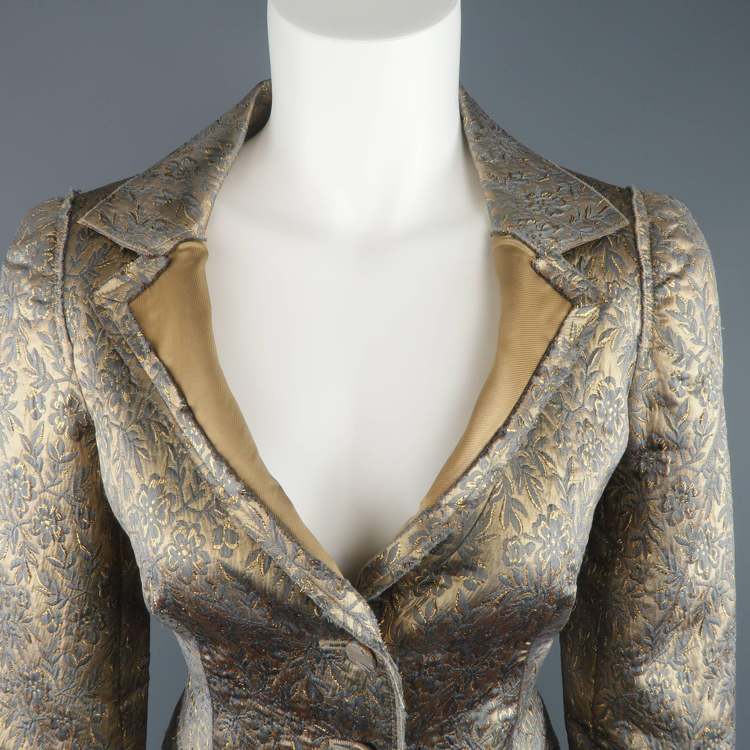 PRADA deconstructed sport coat jacket comes in a metallic gold silk blend floral print brocade material and features a spread notch lapel with extended golden beige liner, raw edge frayed piping throughout, two button closure, and pleated peplum