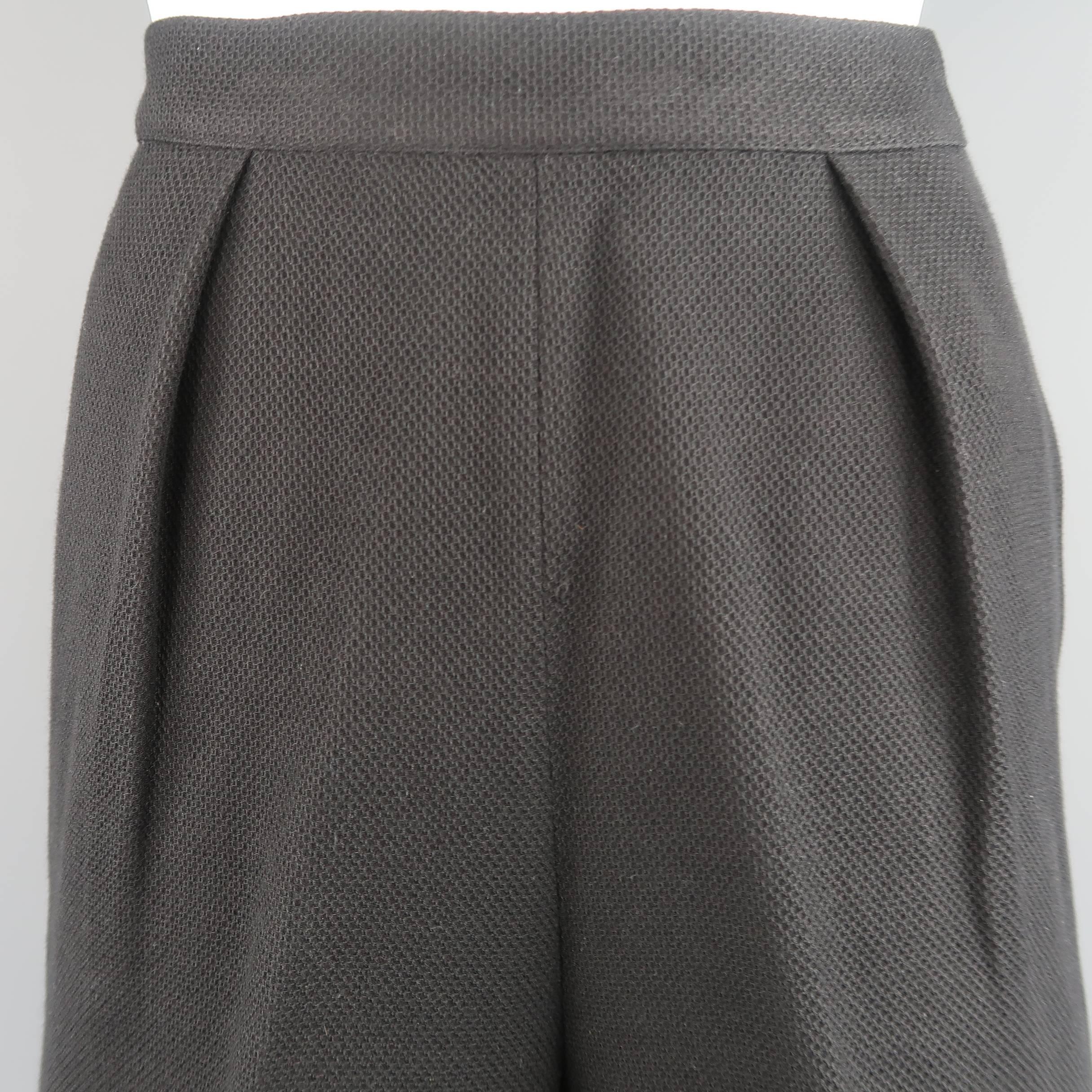 Vintage CHANEL Bermuda shorts come in a textured woven cotton fabric and feature a high rise, pleated front, and side pockets. Made in France.
 
Good Pre-Owned Condition.
Marked: FR 38
 
Measurements:
 
Waist: 27 in.
Hip: 38 in.
Rise: 12 in.
Inseam: