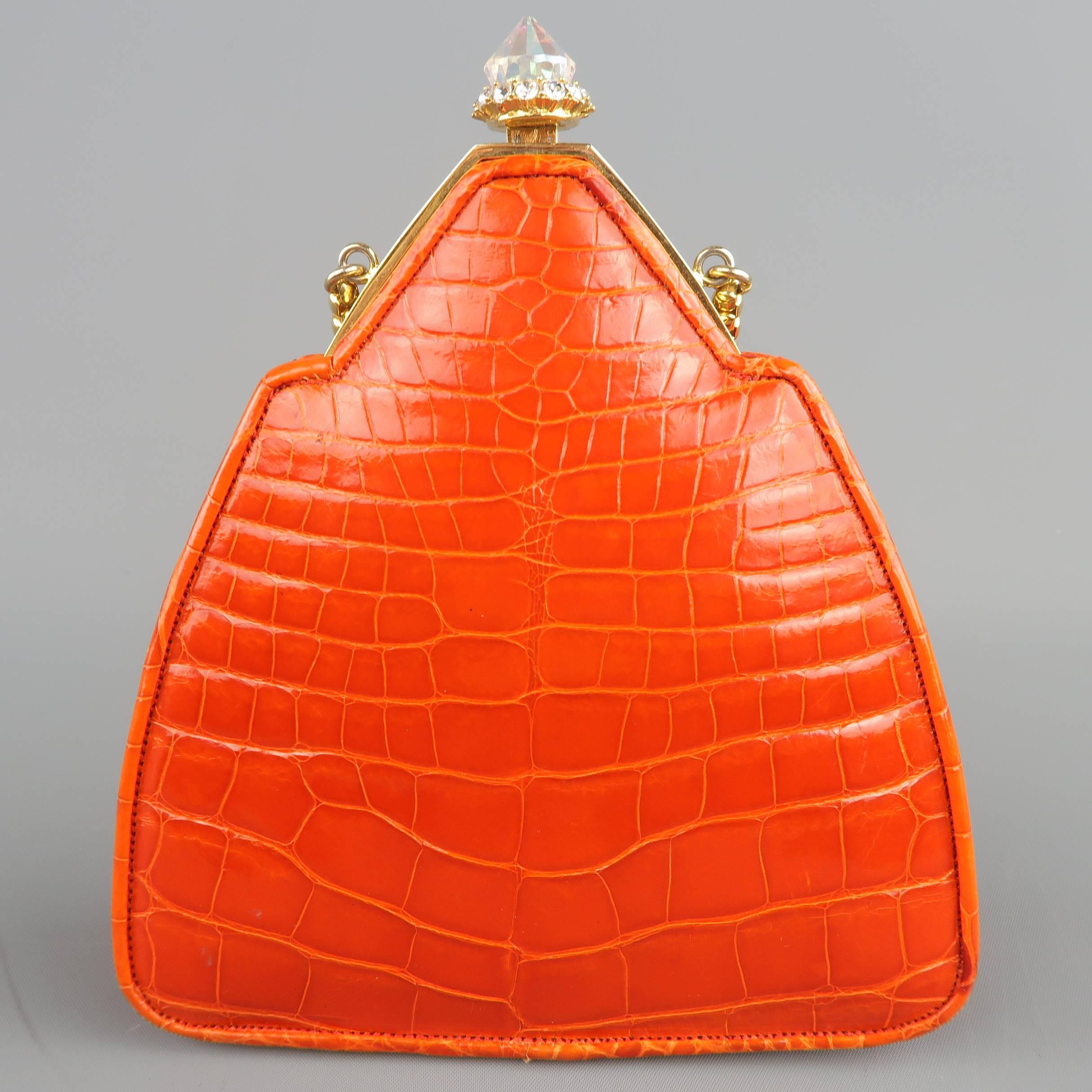 Vintage JUDITH LEIBER purse comes in a vibrant orange alligator leather and features a gold tone clasp with pointed Aurora Borealis jewel surrounded by clear rhinestones, chain strap, and silk satin liner. Minor wear.
 
Good Pre-Owned Condition.

