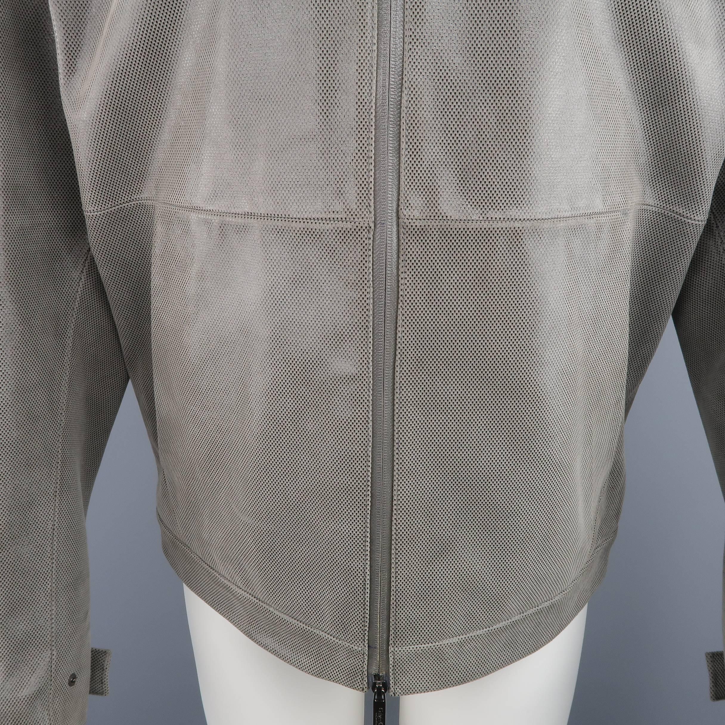 Calvin Klein Collection leather jacket comes in a taupe gray matte sueded leather with all over metallic black micro nailhead print and features a coated double zip front with embossed tabs, pointed collar, slanted pockets, and snap tab cuffs. Made