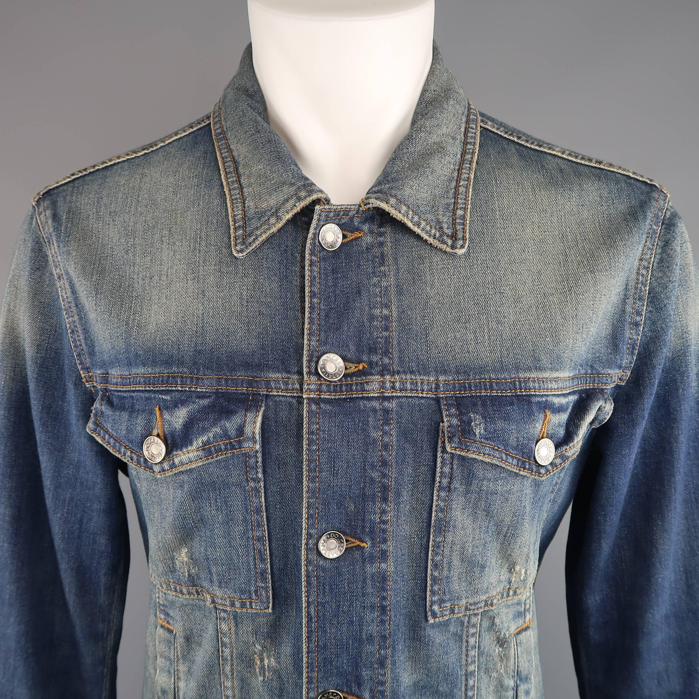DOLCE & GABBANA trucker jacket comes in a light weight dirty washed stretch denim and features a classic pointed collar, patch flap breast pockets, vertical snap slit pockets, metal plaque back tag, and distressing throughout. Made in Italy.
