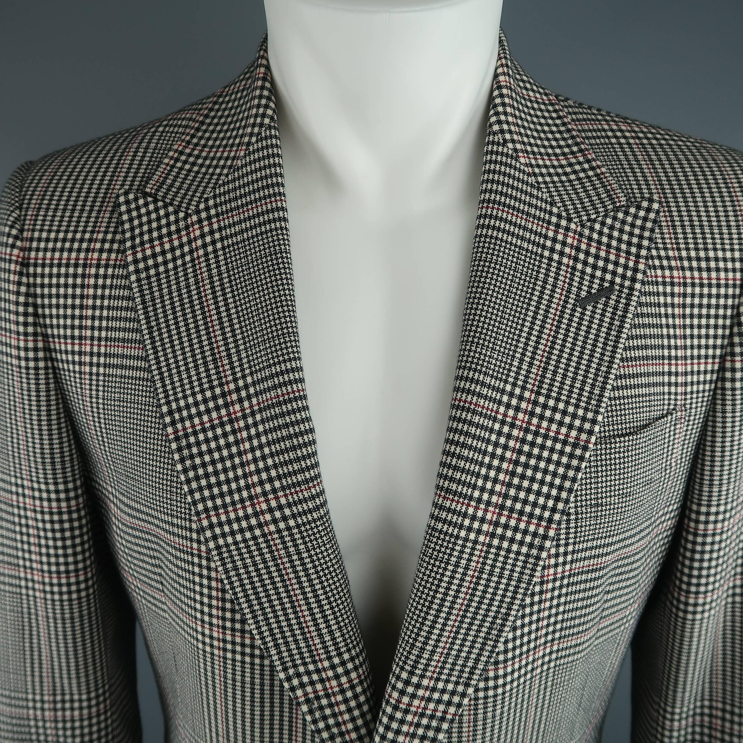Two button GUCCI sport coat comes in an off white and black glenplaid print mohair cotton blend fabric with red stripes throughout and features a pointed peak lapel, slanted flap pockets, faux button cuffs, and double vented back. Half Lined in red