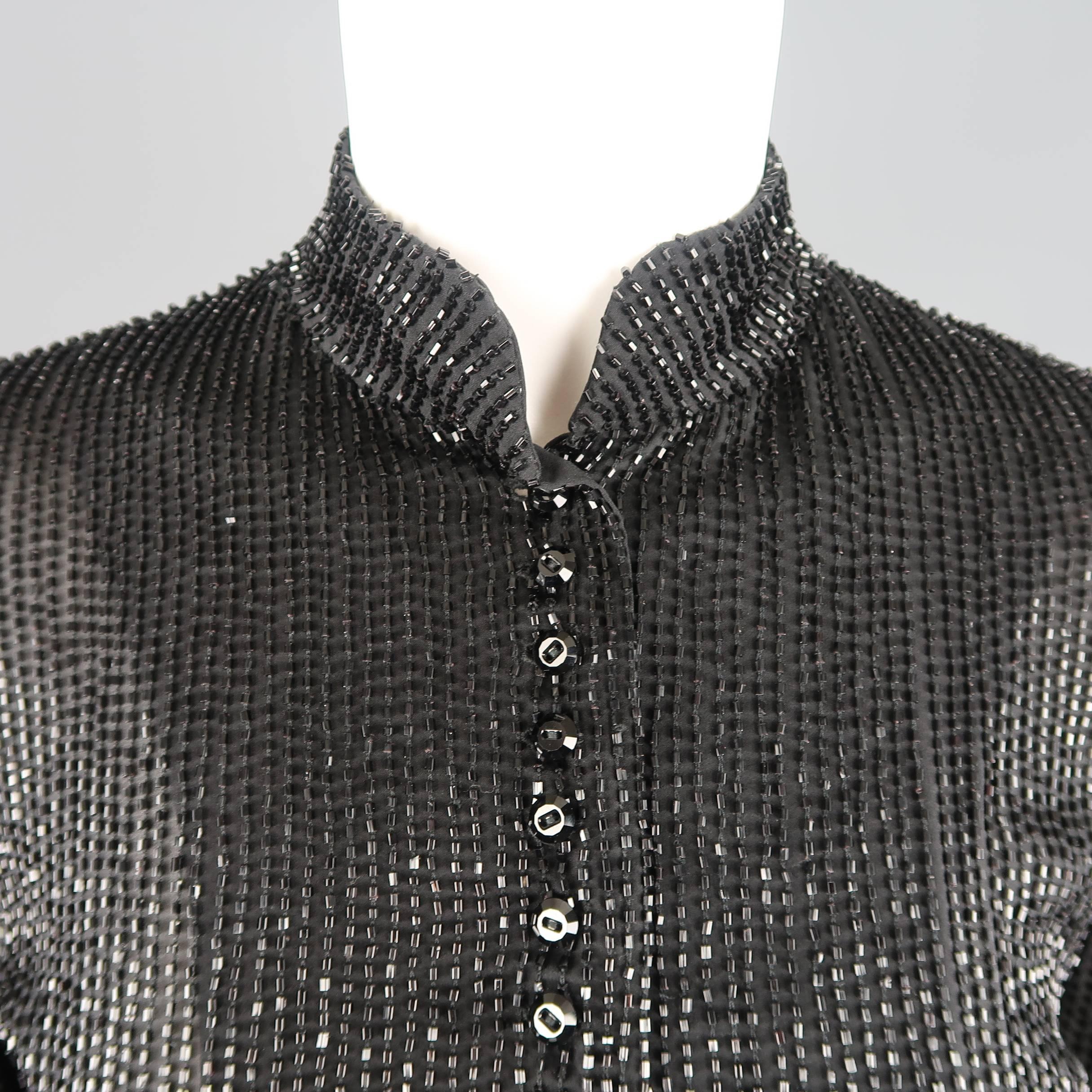 Ralph Lauren Collection cropped evening blouse comes in silk chiffon covered in bugle beads and features a cropped hem, Nehru stand up collar, and crystal cut button up front. Minor wear throughout beading in fabric. Made in USA.  Retailed: