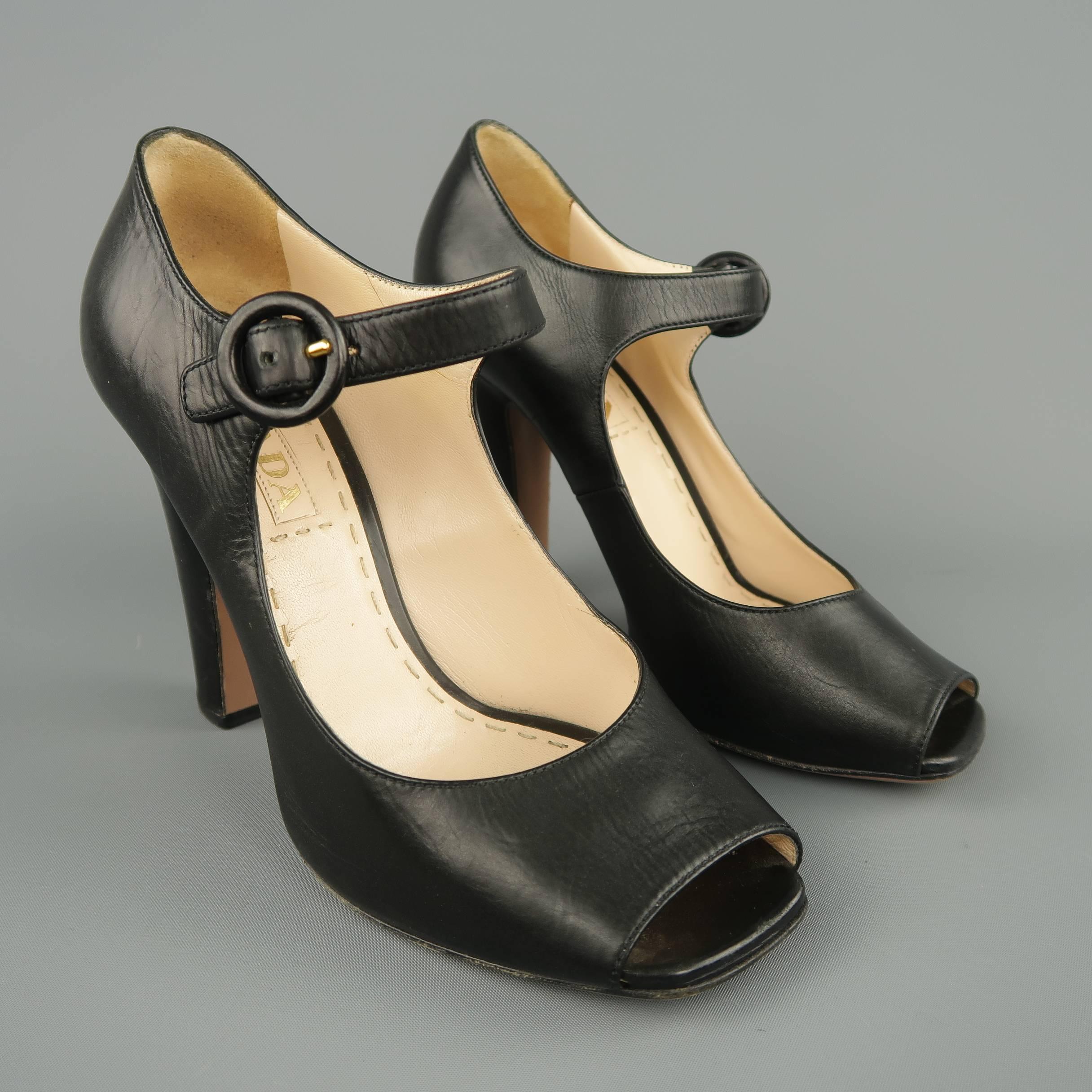 PRADA pumps come in smooth black leather and feature a square peep toe, thick covered heel, and Mary Jane strap. Made in Italy.
 
Good Pre-Owned Condition.
Marked: IT 37.5
 
Measurements:
 
Heel: 4 in.
