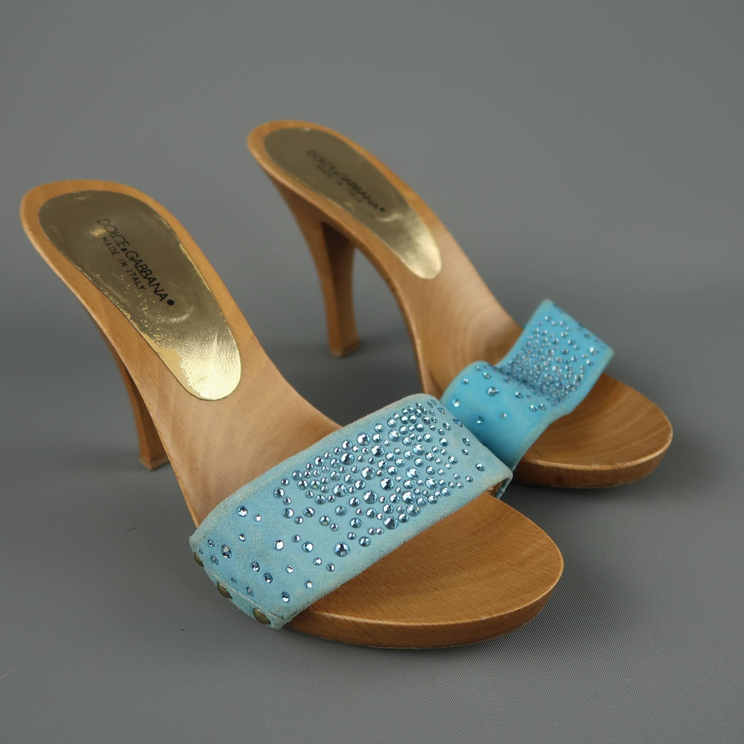 DOLCE & GABBANA mule sandals feature a thick blue suede toe strap with rhinestones and a wooden platform heeled sole. Wear throughout.  Made in Italy.
 
Fair Pre-Owned Condition.
Marked: IT 37
 
Heel: 4.25 in.
Platform: 0.25 in.
