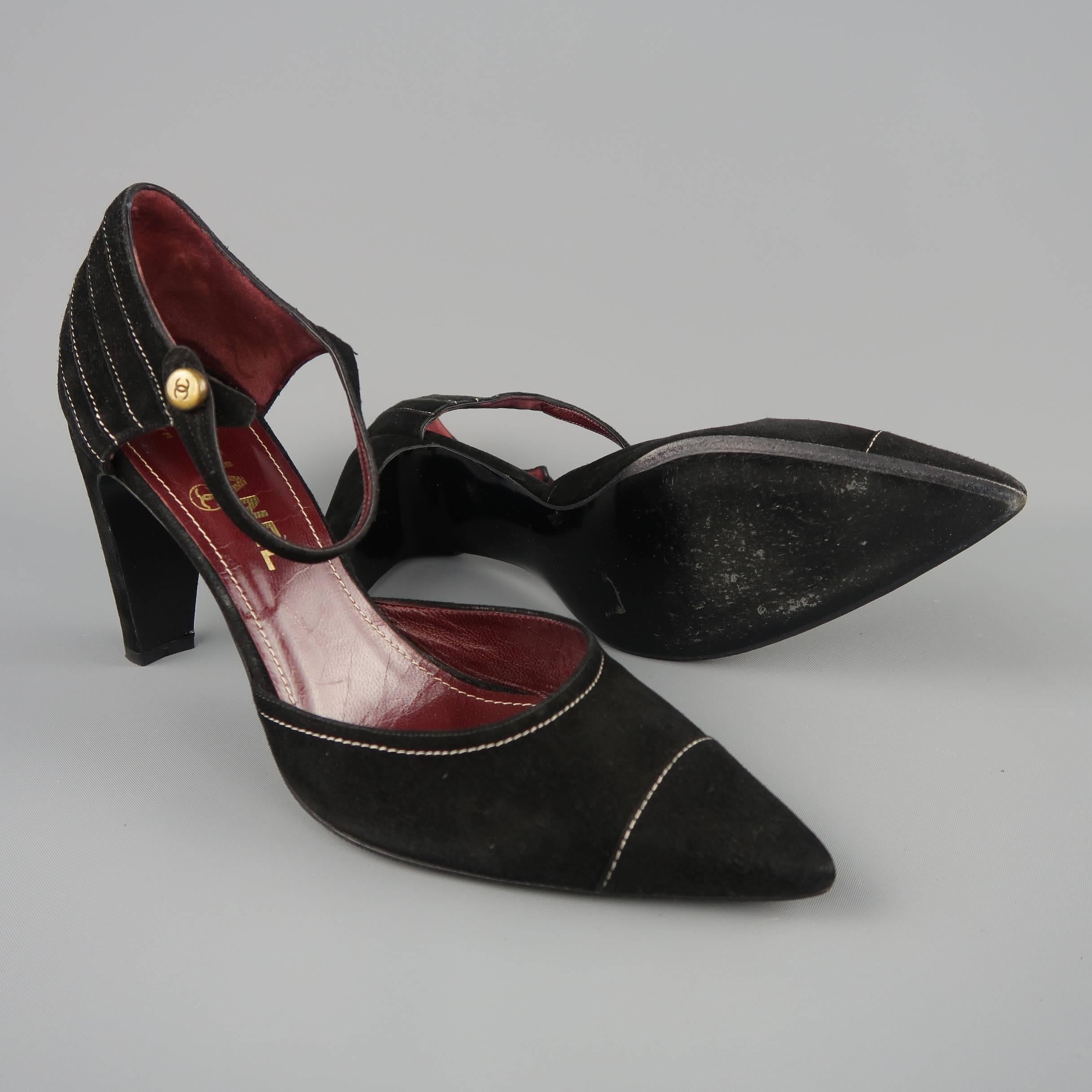 Vintage CHANEL pumps come in black suede with cream contrast stitching details throughout, pointed cap toe, thick covered heel, and ankle strap with antique gold tone CC button.  Made in Italy.
 
Good Pre-Owned Condition.
Marked: IT 39.5
