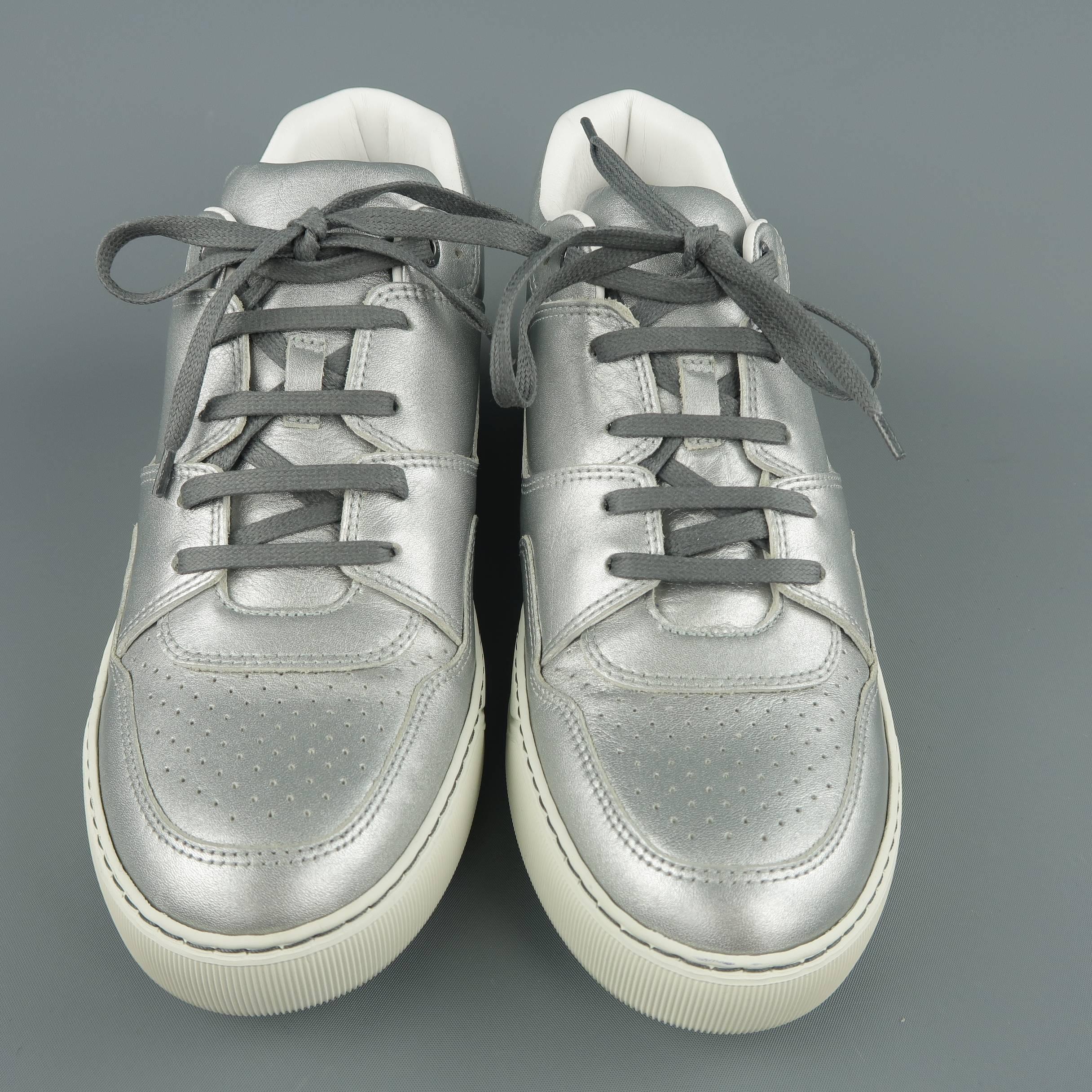 LANVIN mid sneakers come in metallic silver leather with a perforated toe panel and thick off white rubber sole. Made in Portugal.
 
New in Box.
Marked: UK 7
 
Outsole: 11.45 x 4 in.
