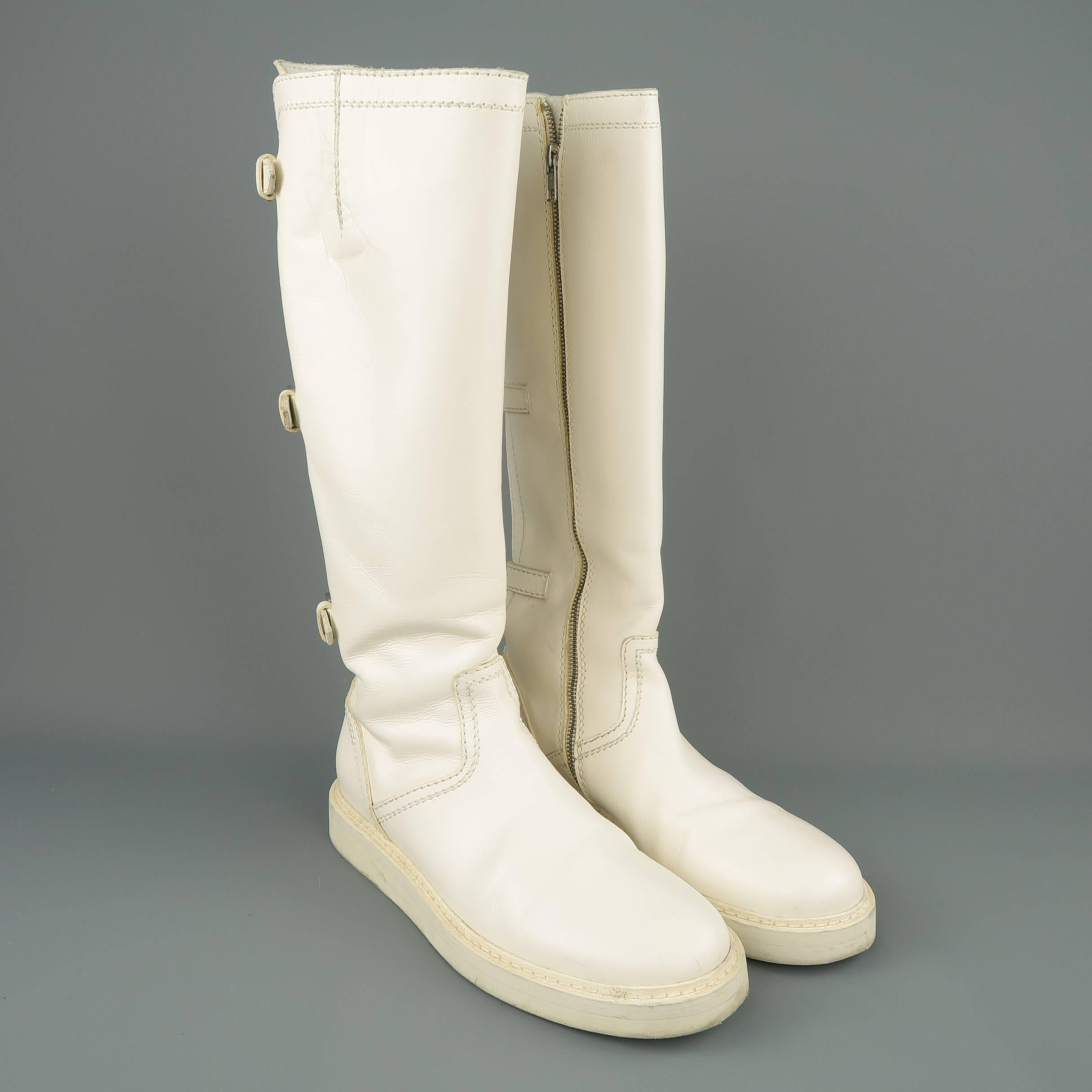 ANN DEMEULEMEESTER knee high boots come in off white leather with a round toe, thick rubber sole, buckle strapped back, and internal zip closure. Made in Italy.
 
Good Pre-Owned Condition.
Marked: IT 41
 
Measurements:
 
Outsole: 12 x 4.5