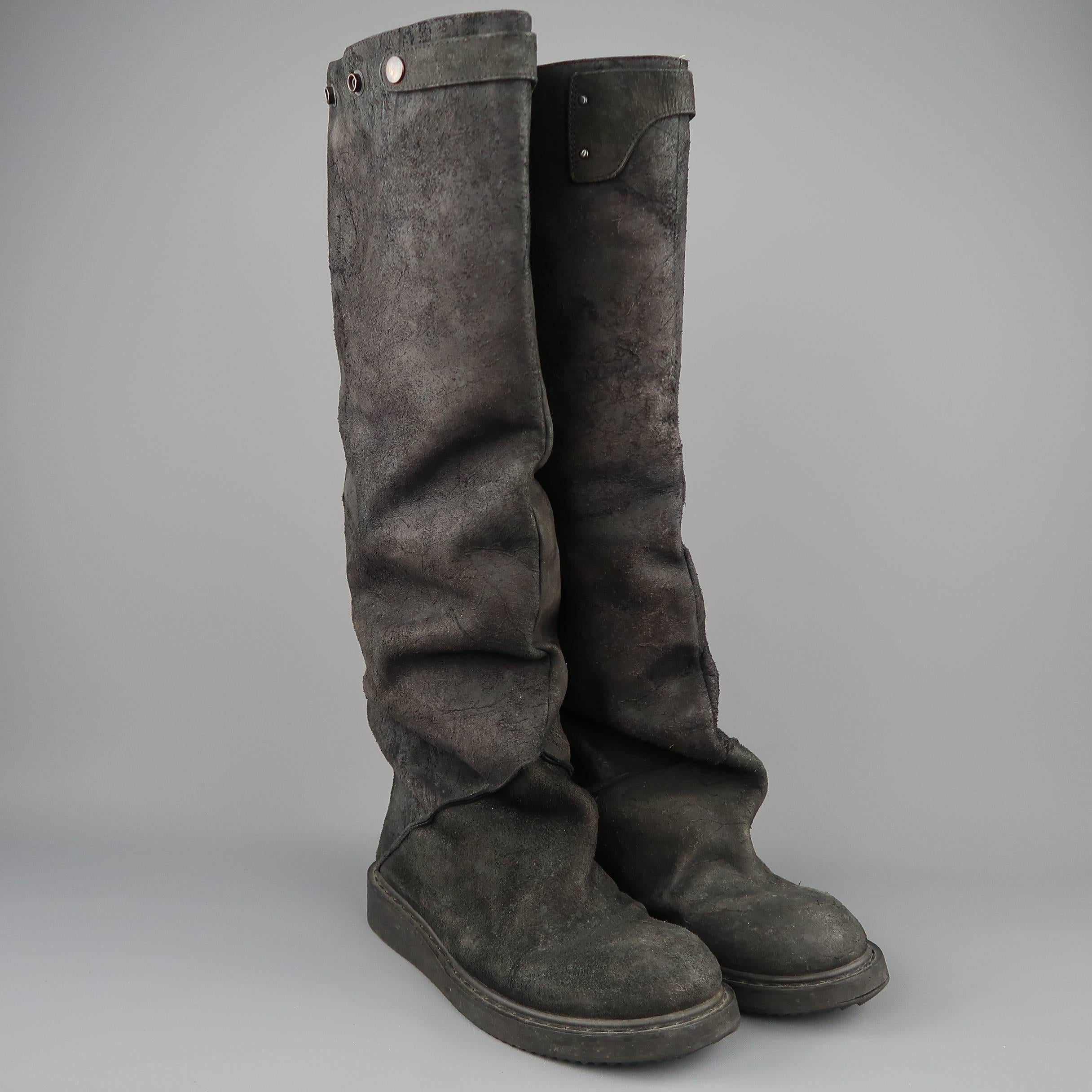 RICK OWENS knee high boots come in black sueded distressed leather with a round toe, thick sole, oversized slouchy construction, and back zip closure. Wear throughout. Made in Italy.
 
Good Pre-Owned Condition.
Marked: IT 41
 
Measurements:
