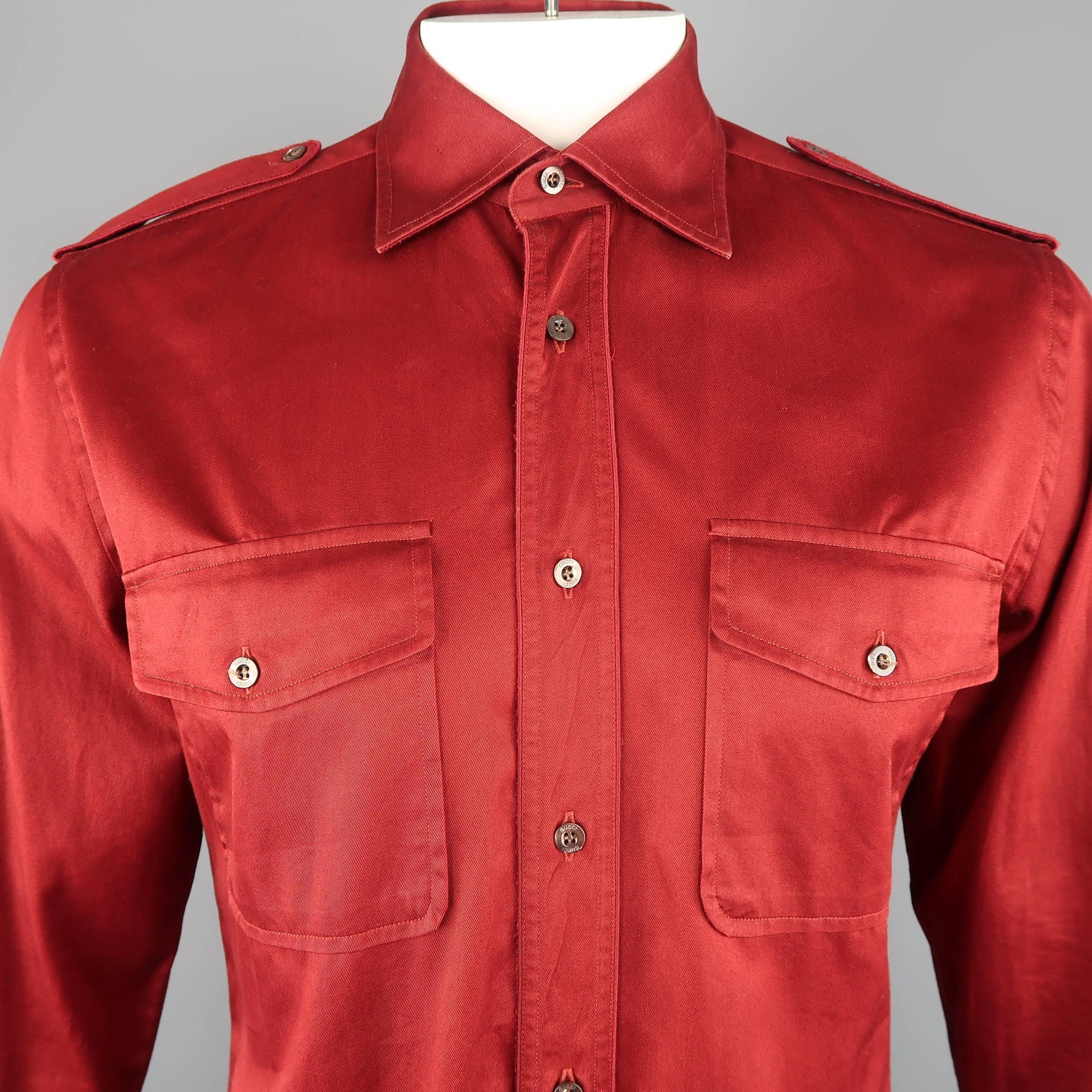 GUCCI military style comes in burgundy red cotton twill with a pointed spread collar, epaulets, patch flap pockets, and satin piping throughout. Made in Italy.
 
Good Pre-Owned Condition.
Marked: 41  16
 
Measurements:
 
Shoulder: 18 in.
Chest: 42