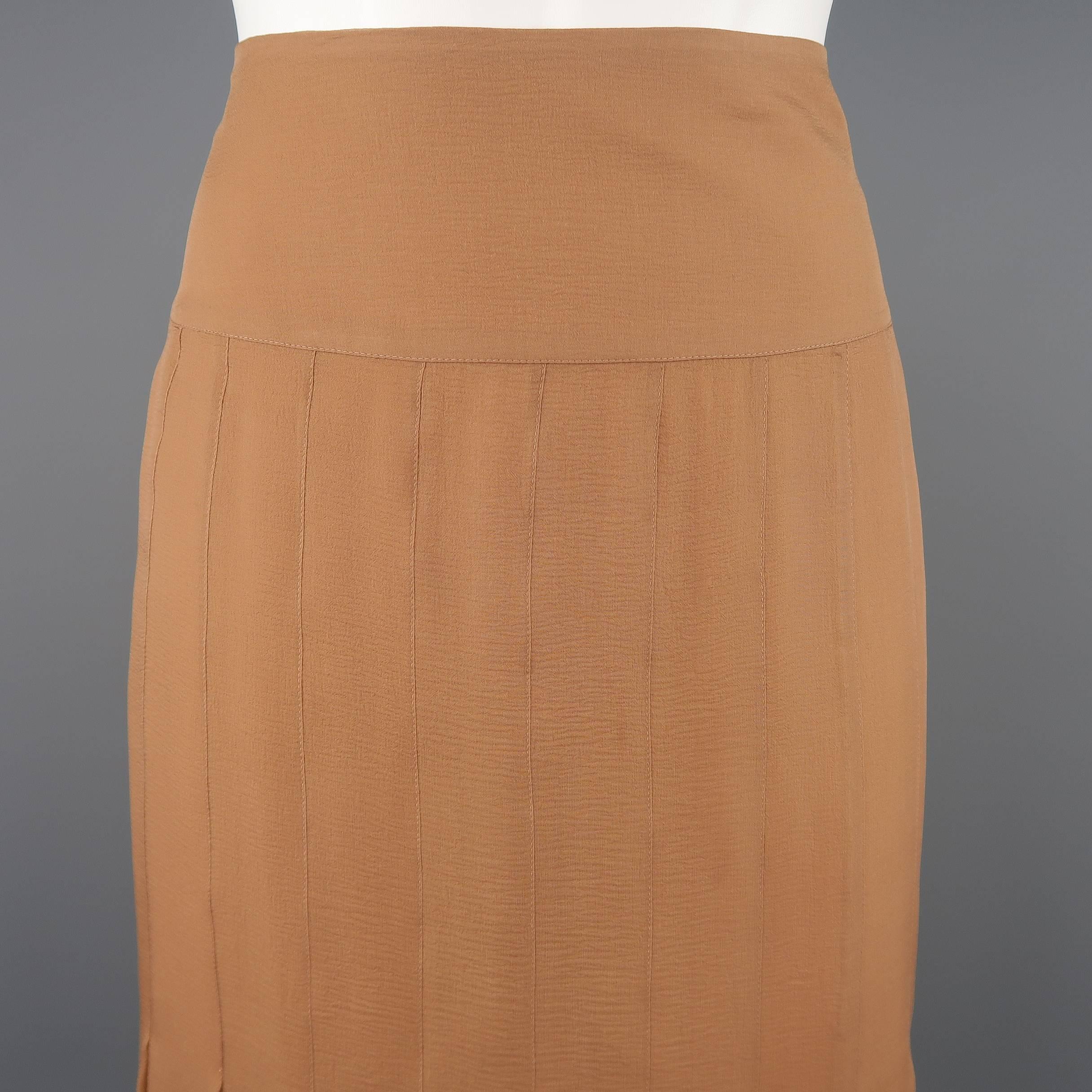 CHANEL pencil skirt comes in tan beige silk crepe chiffon with a box pleated construction, pleated hem, and thick waistband. Made in France.
 
Excellent Pre-Owned Condition.
Marked: FR 40  03A
 
Measurements:
 
Waist: 30 in.
Hip: 40 in.
Length: 22.5