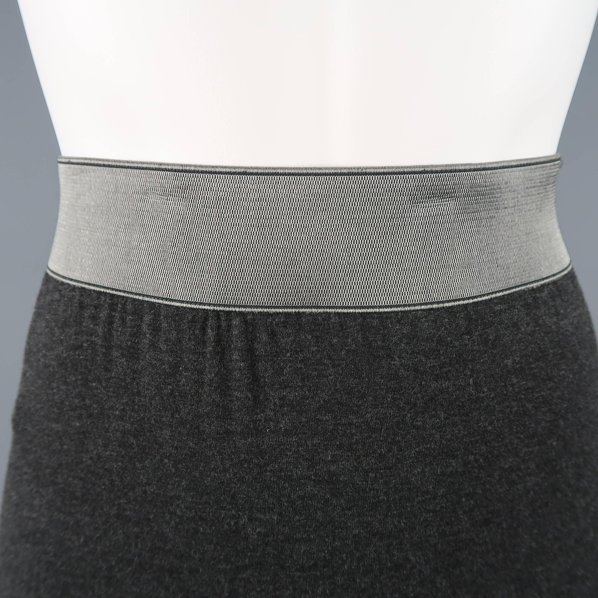 DONNA KARAN pencil skirt comes in charcoal heather gray stretch jersey with a thick metallic silver elastic waistband.
 
Excellent Pre-Owned Condition.
Marked: M
 
Measurements:
 
Waist: 29 in.
Hip: 38 in.
Length: 32 in.
