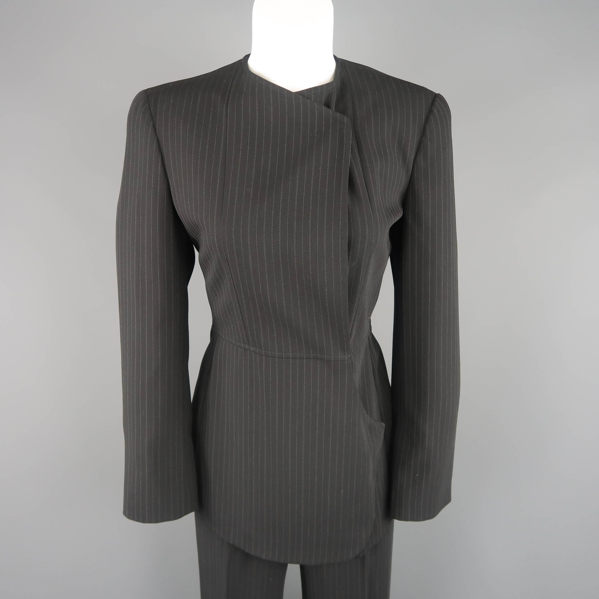 This GIORGIO ARMANI pants suit comes in black and gray pinstripe wool and includes a collarless jacket with a double breasted graphic line snap closure and matching flat front trousers. Made in Italy.
 
Excellent Pre-Owned Condition.
Marked: IT 40 /