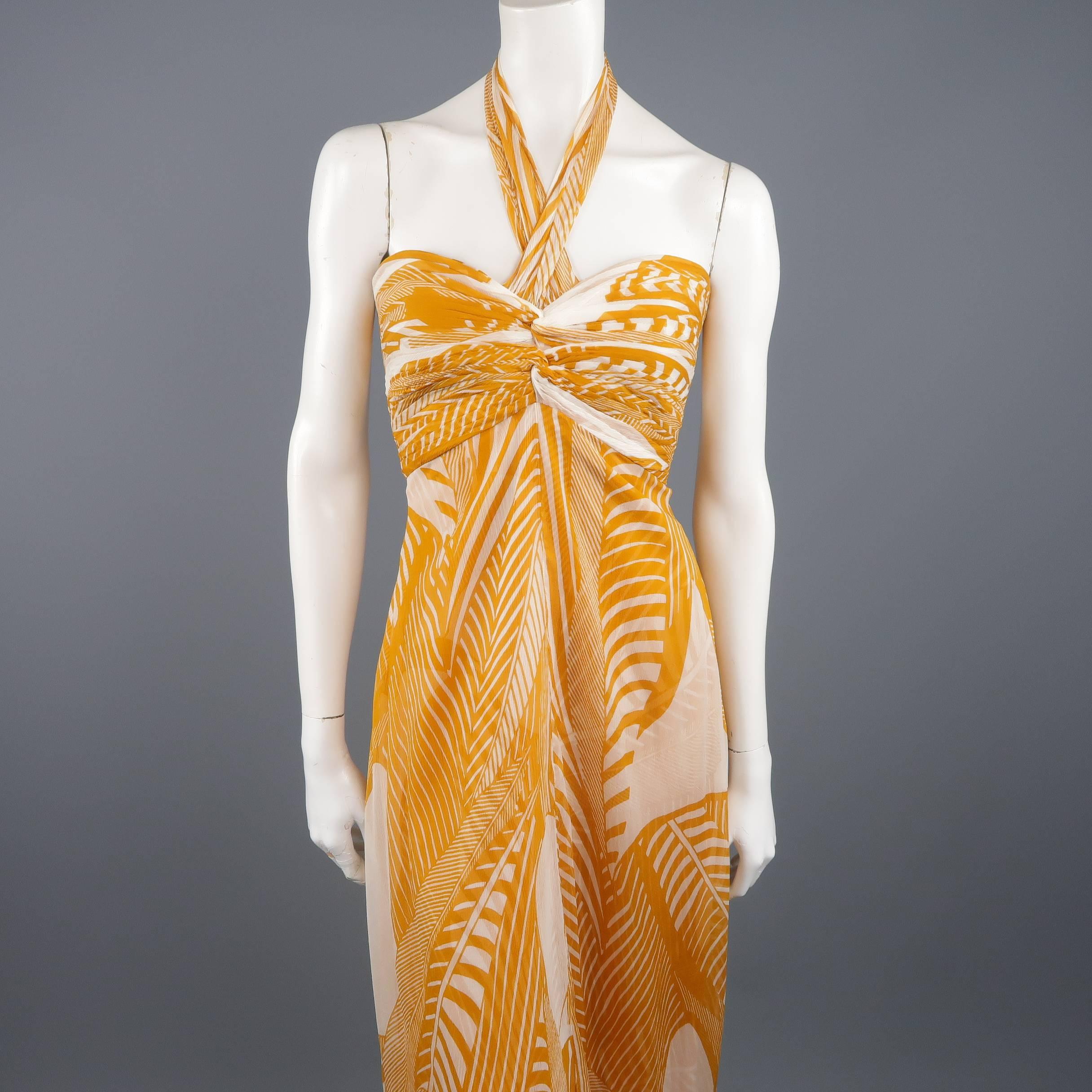 MONIQUE LHUILLIER cocktail dress comes in gold and cream printed silk chiffon with a pleated bralette, tied halter top, and long, empire waist, A line skirt. Made in USA.  Retailed $3,000.00
Excellent Pre-Owned Condition.
Marked: 8
