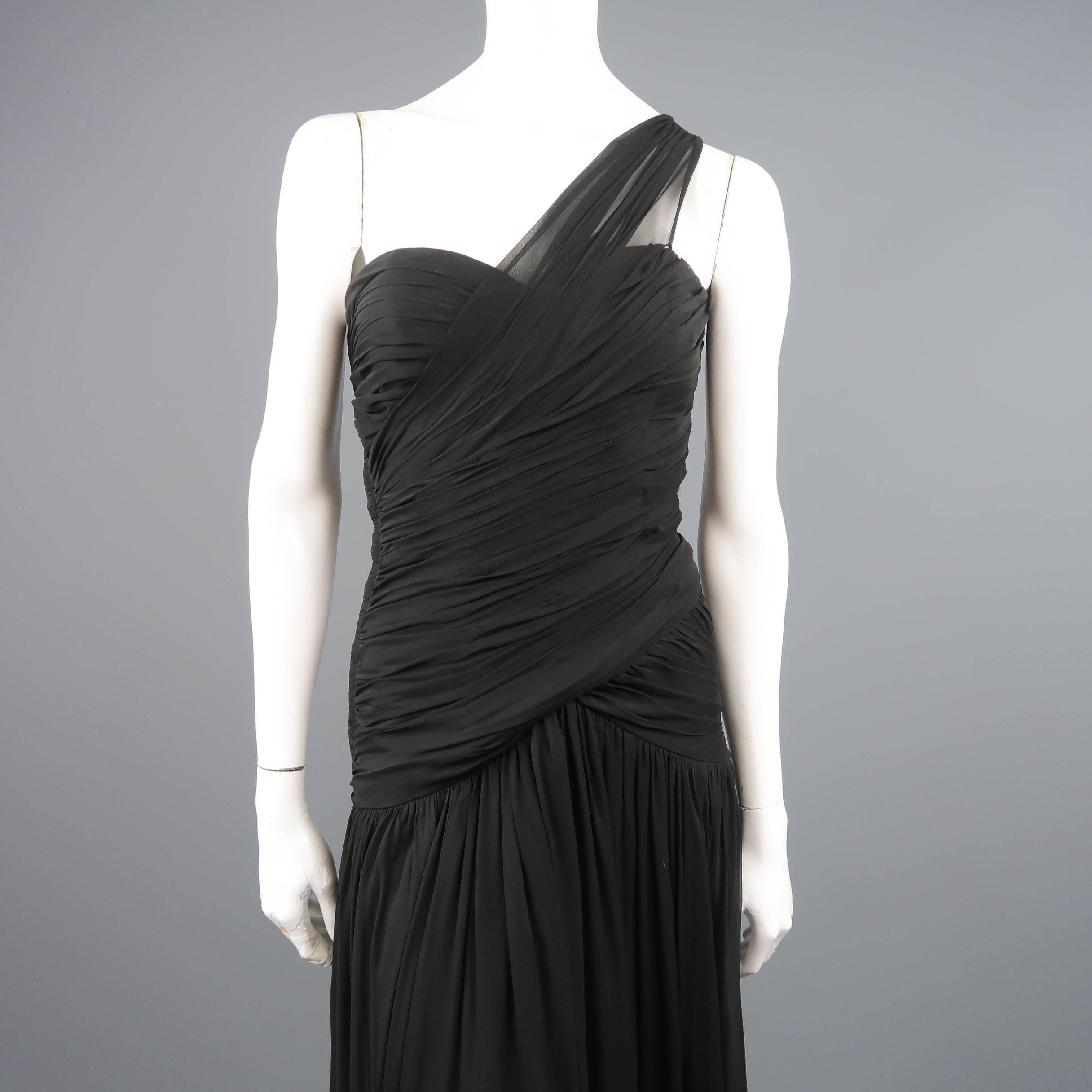 Vintage I. MAGNIN by ADELE SIMPSON cocktail dress comes in black silk chiffon and features a pleated bustier bodice with a sweetheart neckline, diagonal gathered shoulder strap, and long drop waist gathered skirt. Minor wear throughout. Made in