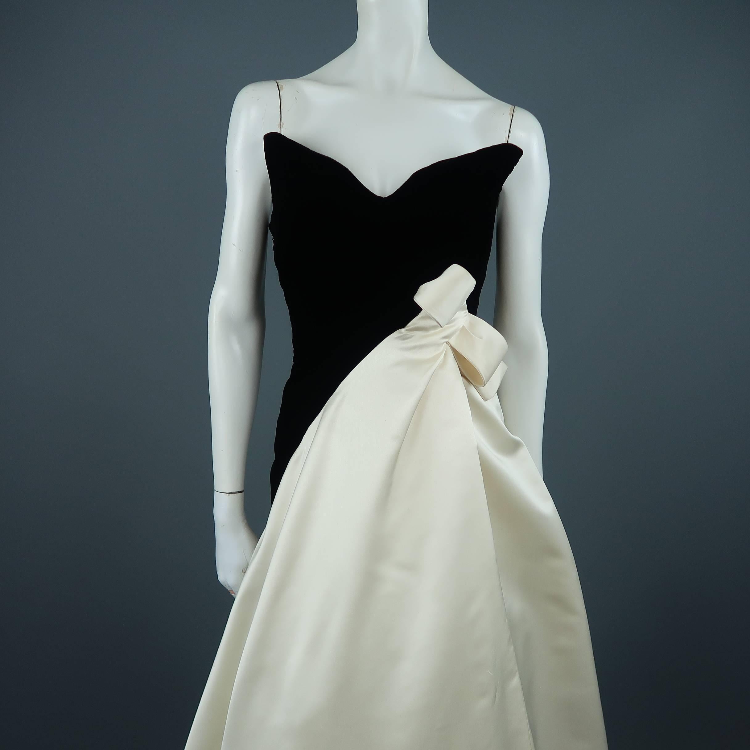 Vintage BOUTIQUE by SCAASI for I.MAGNIN gown by legendary fashion designer Arnold Scaasi features a black velvet bustier bodice with pointed sweetheart neckline and asymmetrical cream silk satin skirt with bow detail at waist and full tulle