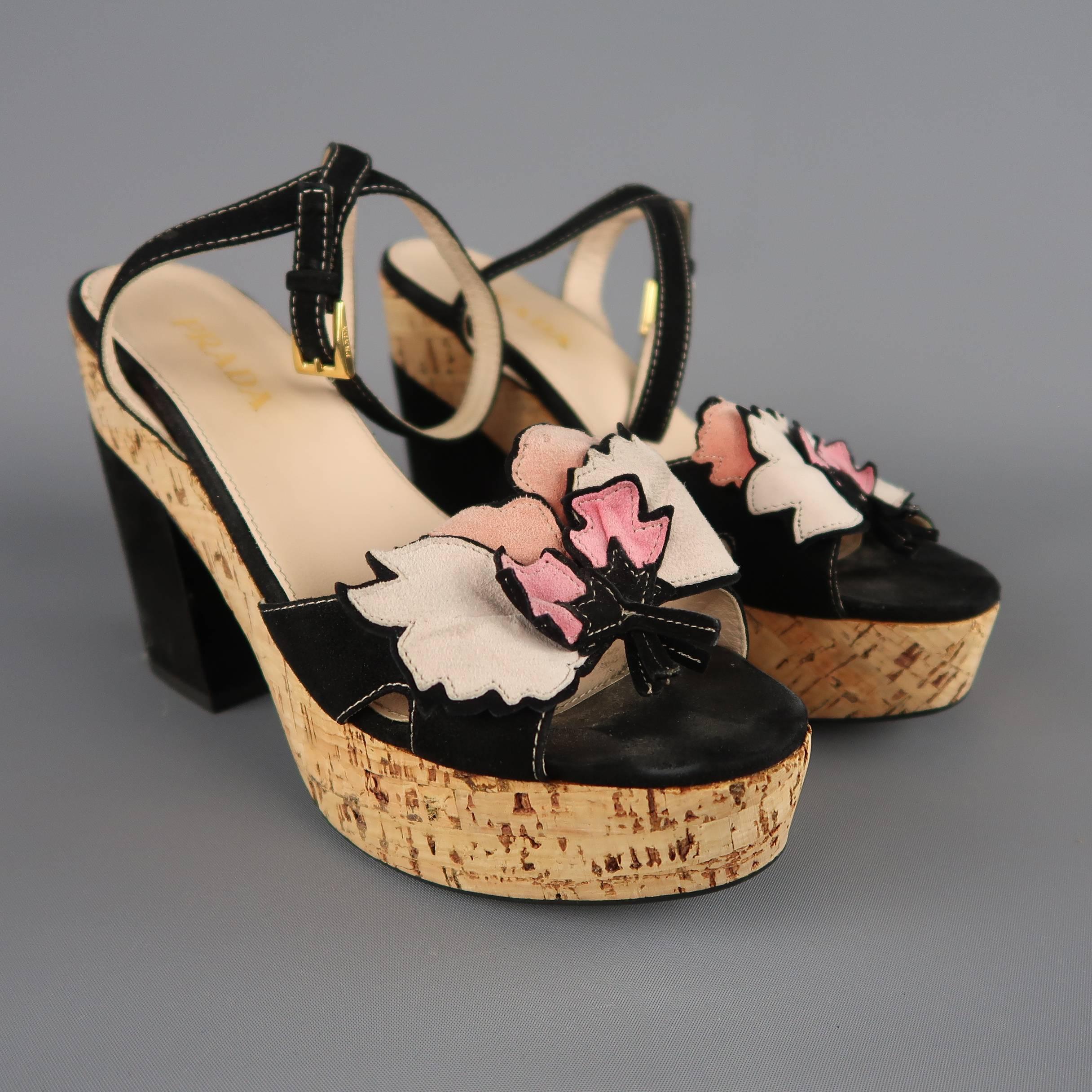 PRADA come in black suede with a pink suede applique toe strap, ankle harness, chunky covered heel, and thick cork platform. Wear throughout. Made in Italy.
 
Fair Pre-Owned Condition.
Marked: IT 36
 
Measurements:
 
Heel: 4.5 in.
Platform: 1.5 in.
