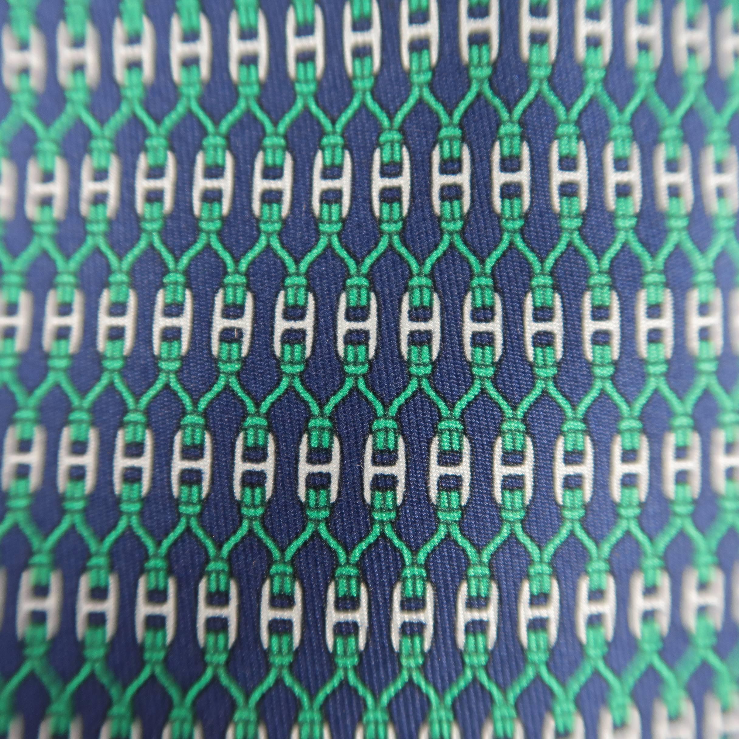 Vintage HERMES necktie comes in navy blue silk twill with all over green interlock rope knot and silver H buckle print. Made in France.
 
Excellent Pre-Owned Condition.
 
Width: 3.25 in.
