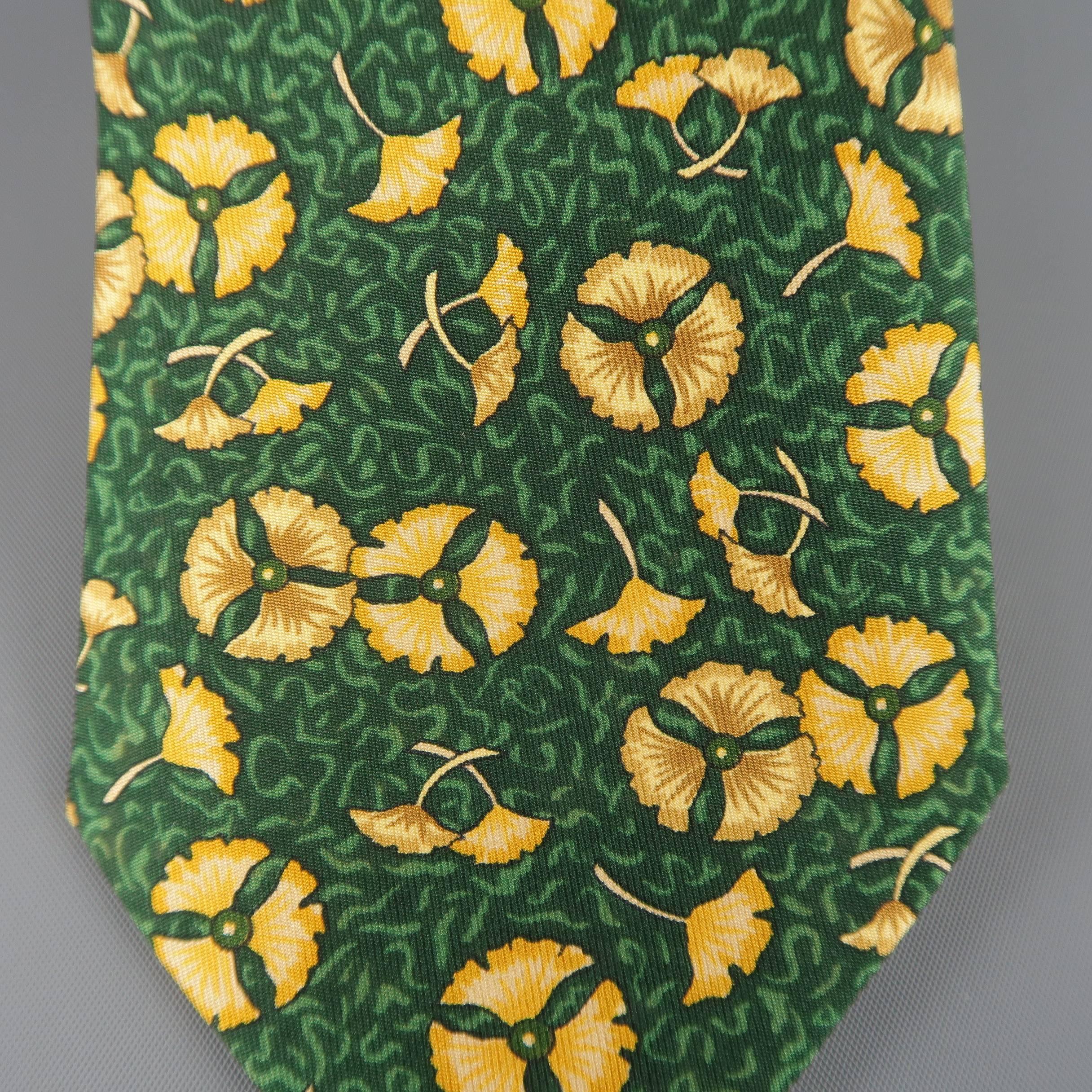 Vintage HERMES necktie comes in dark green silk twill with all over gold flower petal print. Made in France.
 
Good Pre-Owned Condition.
 
Width: 3.45 in.
