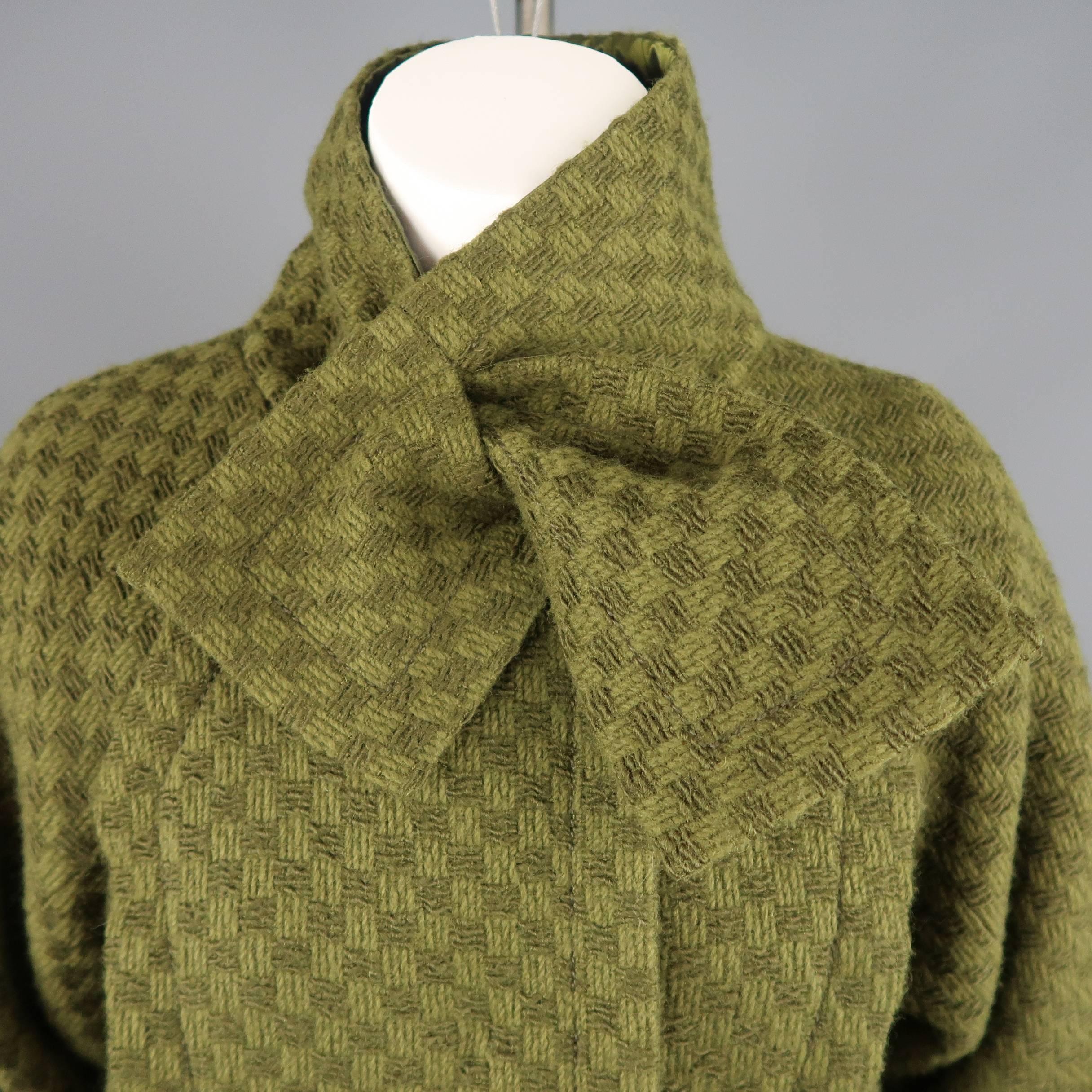 Louis Vuitton coat comes in army green Damier checkered textured wool tweed and features a high, bow sash collar, pleated pockets, overlay chest, gathered sleeves, and pleat slit back. Made in France.
 
Excellent Pre-Owned Condition.
Marked: FR 36
