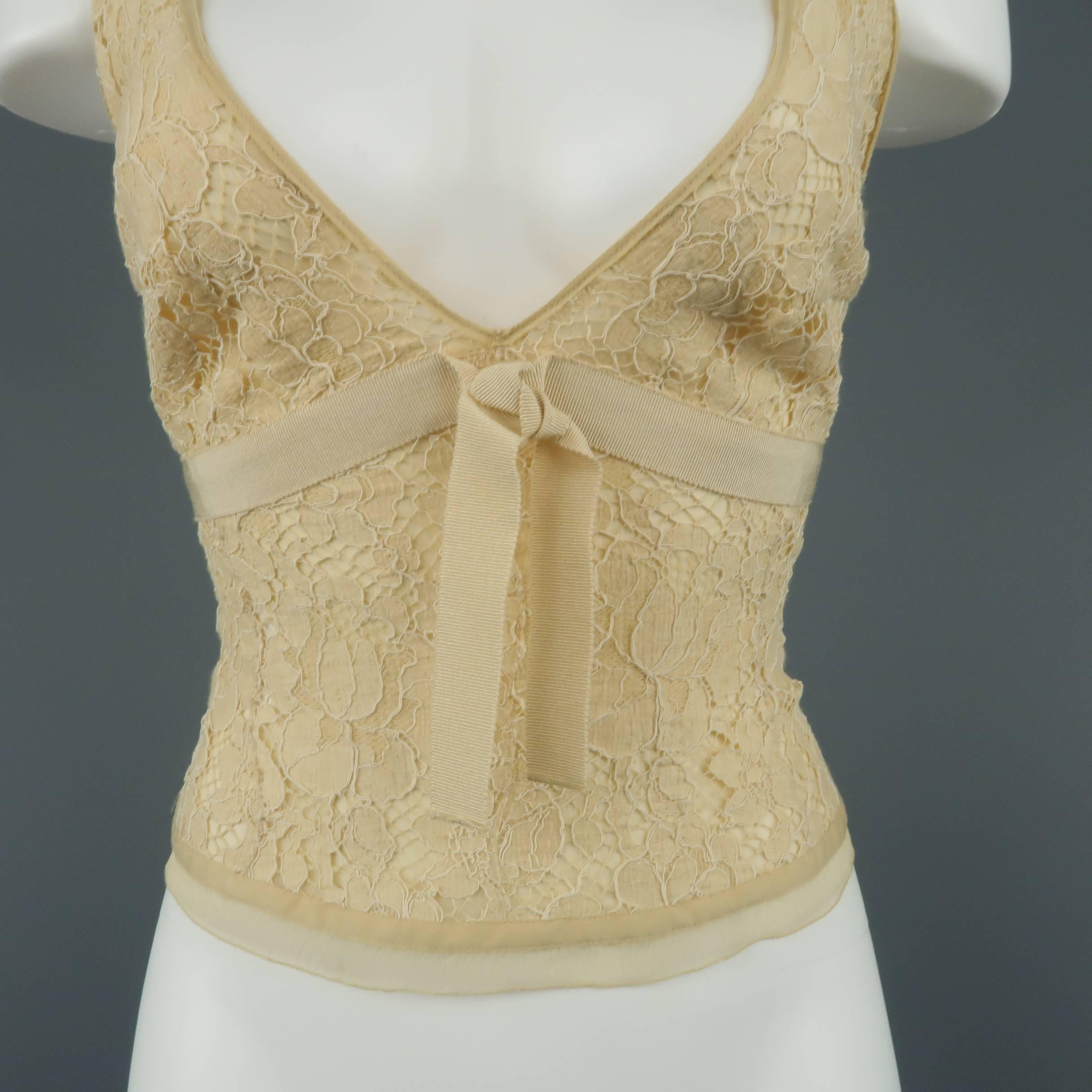 PRADA bralette top comes in beige lace with a chiffon liner and grosgrain ribbon bow waistband. Tears in liner. As-is. Runs very small. Matching skirt available separately. Made in Italy.
 
Fair Pre-Owned Condition.
Marked: IT 44
 
Measurements:
