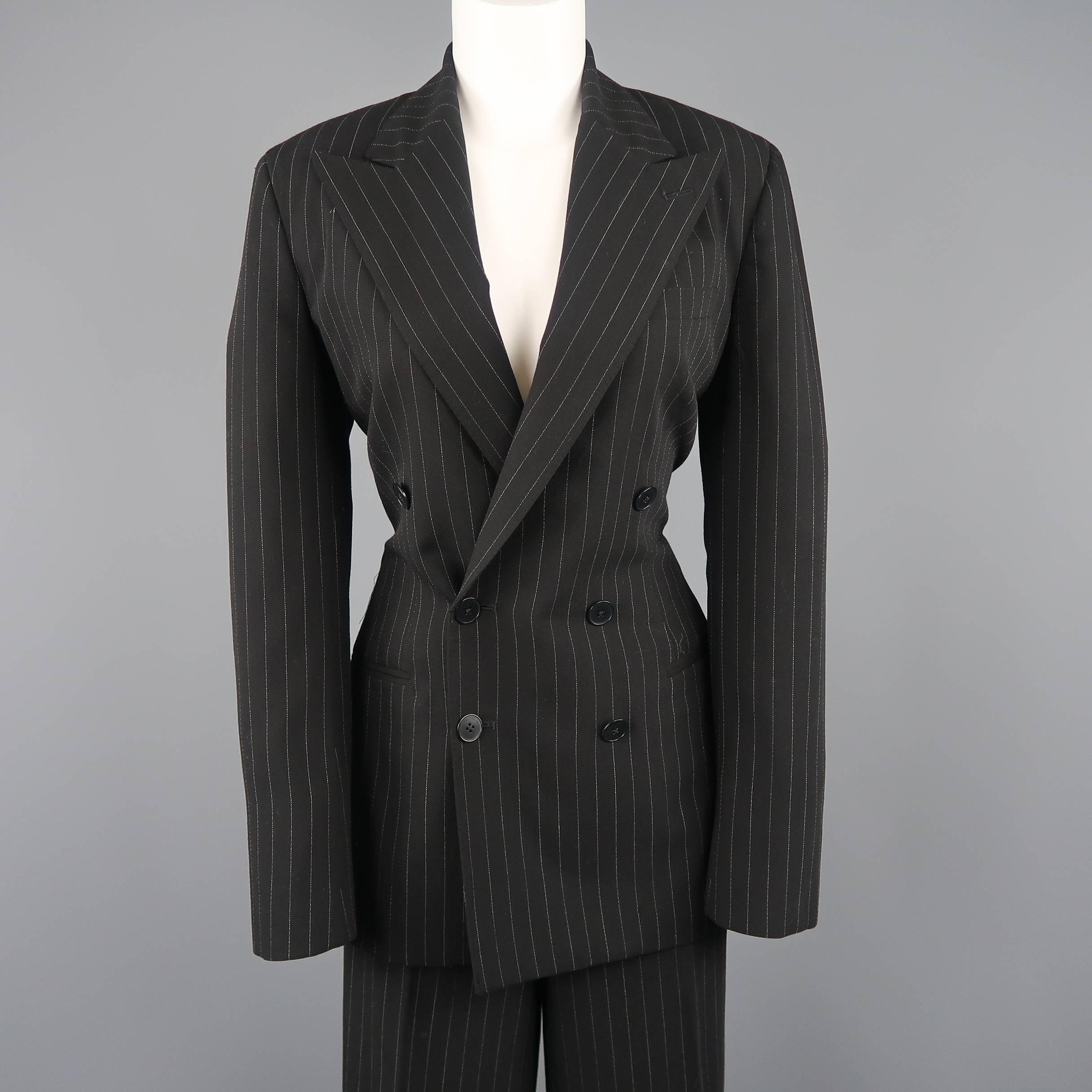 Ralph Lauren Collection suit comes in black pinstripe wool and includes a double breasted, peak lapel jacket and matching high rise, flat front, wide leg trousers with a back belt. Made in USA.
 
Excellent Pre-Owned Condition.
Marked: 8
