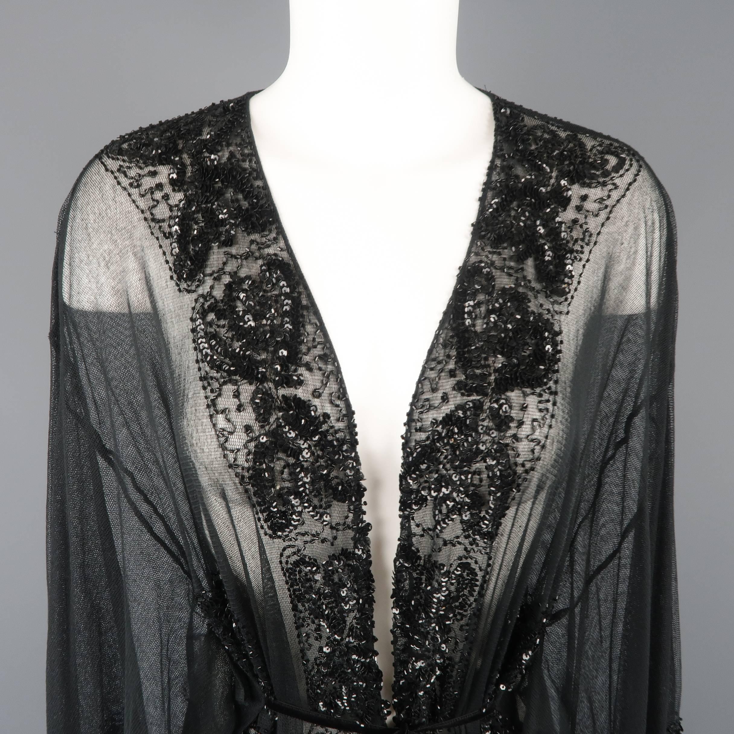 This gorgeous kimono style cardigan by COLLETTE DINNIGAN comes in soft black micro mesh tulle with wide sleeves, black velvet ribbon tie front, and glass and sequin beadwork throughout. Made in Australia.
 
New with tag.
Marked: S
 
Measurements:
