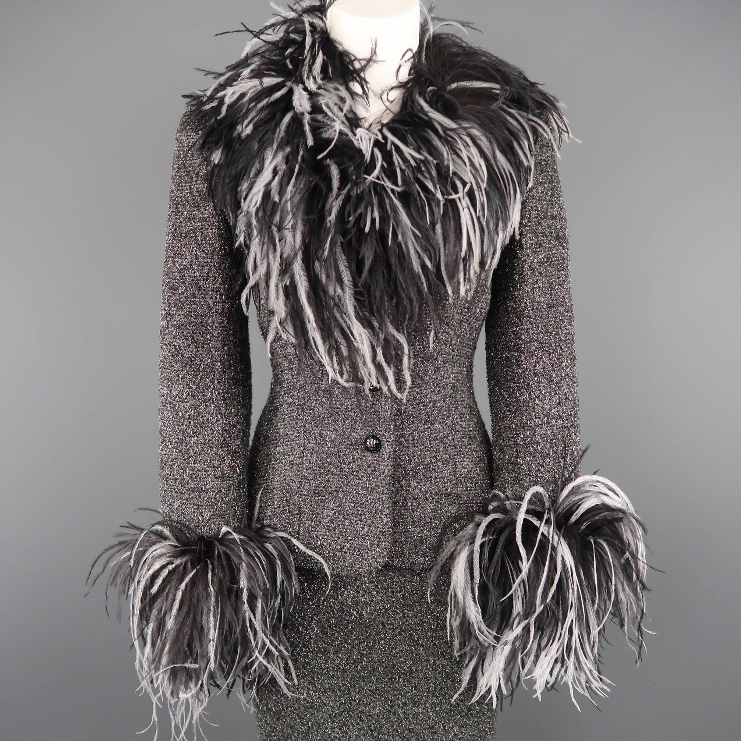 This fabulous vintage ESCADA COUTURE suit comes in gray lurex sparkle blended boucle and includes a tailored jacket with four crystal button closure and black and white ostrich feather collar and cuffs with a matching pencil skirt.
 
Excellent