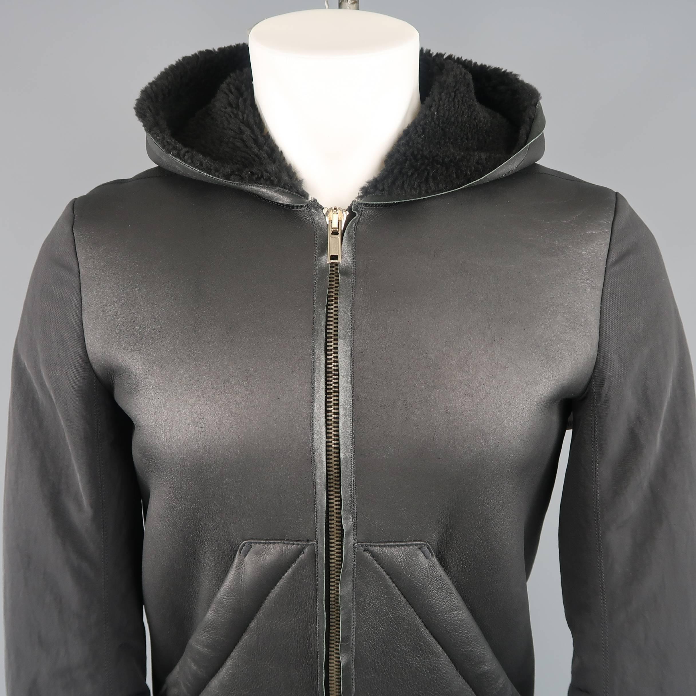 RICK OWENS jacket comes in black shearling fur lined leather with diagonal patch pockets, zip front, full hood, and down filled nylon twill bomber jacket sleeves. Made in Italy.
Excellent Pre-Owned Condition.
Marked: 38
 
Measurements:
 
Shoulder: