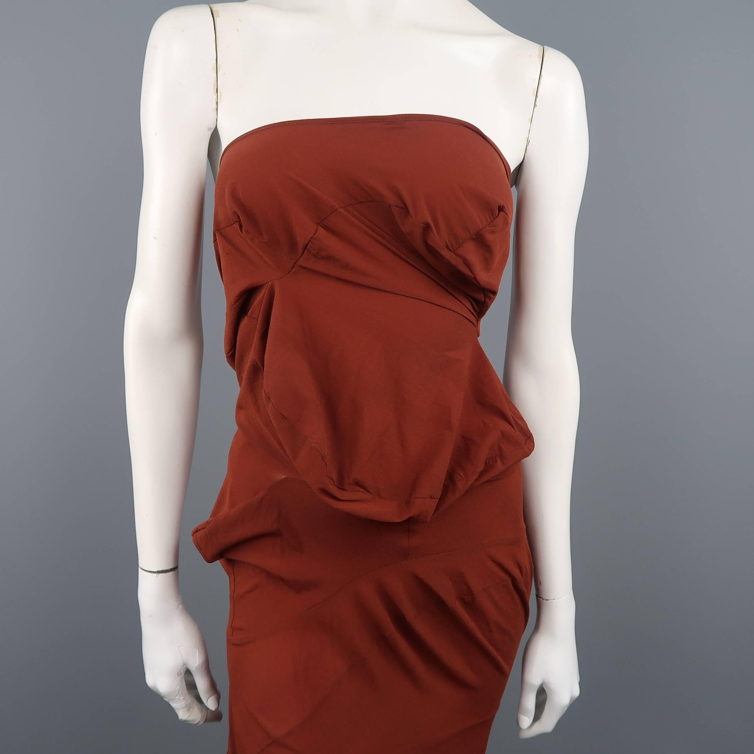 Vintage COMME des GARCONS strapless tube dress comes in a rust brown ultra light weight stretch crepe and features all over avant garde patchwork pattern lump silhouette construction. Minor wear. Tags cut. As-is.
 
Fair Pre-Owned Condition.
Marked: