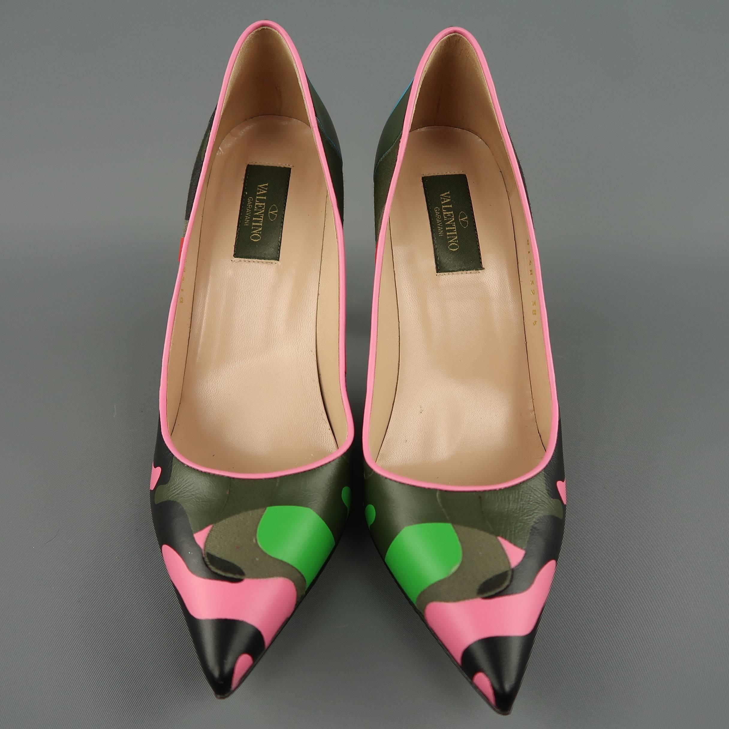VALENTINO pumps come in signature multi color Psychedelic Camouflage leather with canvas details and feature pink piping, a pointed toe, green leather stiletto heel, and gold tone Rockstud detail. Worn once with a couple small scuffs. As-is. Made in