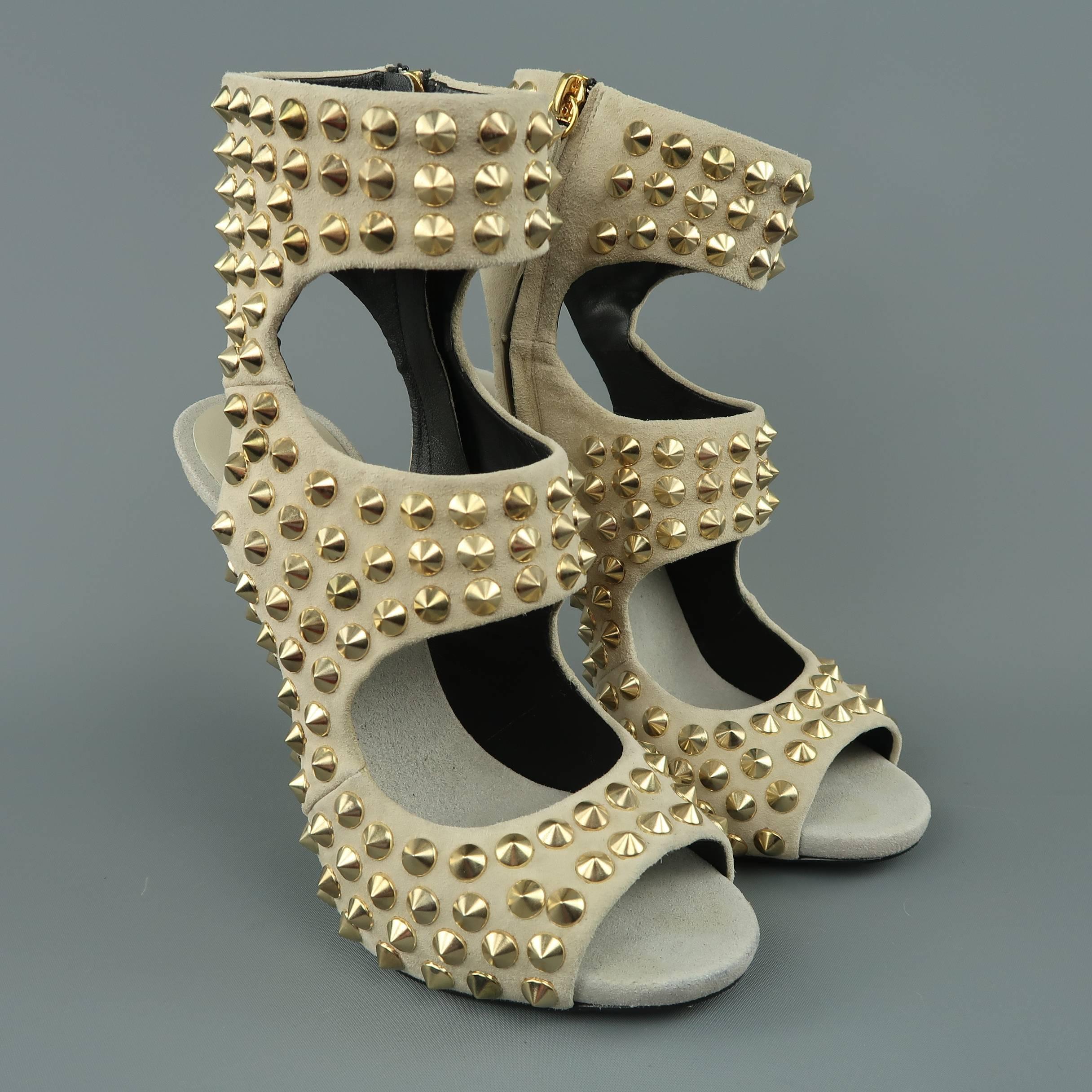 GIUSEPPE ZANOTTI sandals come in beige suede with gold tone cone spike studs throughout, thick straps, peep toe, open back, and underslung heel. Wear throughout. Made in Italy.
 
Good Pre-Owned Condition.
Marked: IT 39
 
Heel: 5.5 in.
