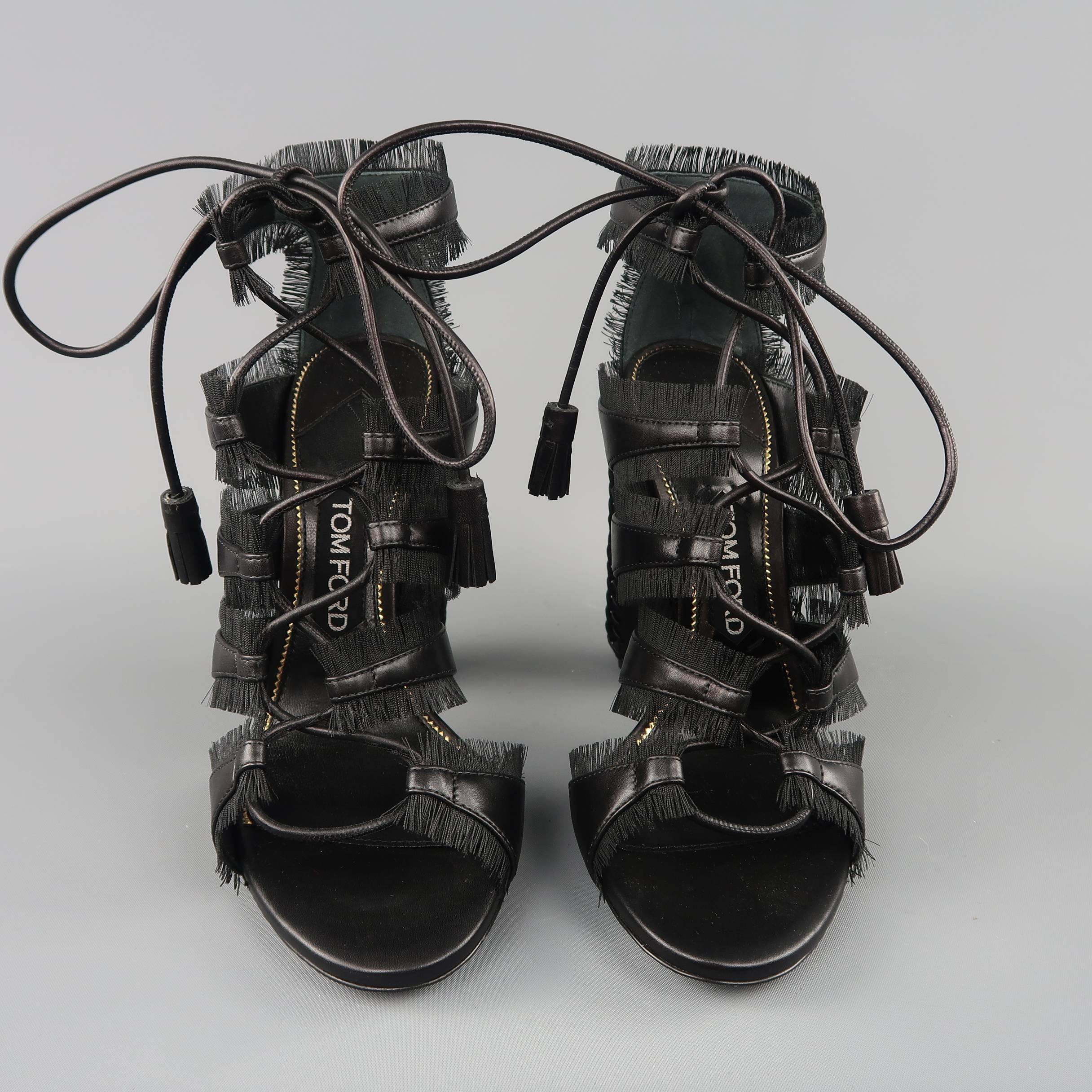 TOM FORD cage sandals come in black smooth leather with eyelash fringe trim, lace up front, and chunky heel with braided trim edges. Made in Italy.  Retails: $1490.00
 
Brand New.
Marked: IT 38
 
Heel: 4.5 in.
