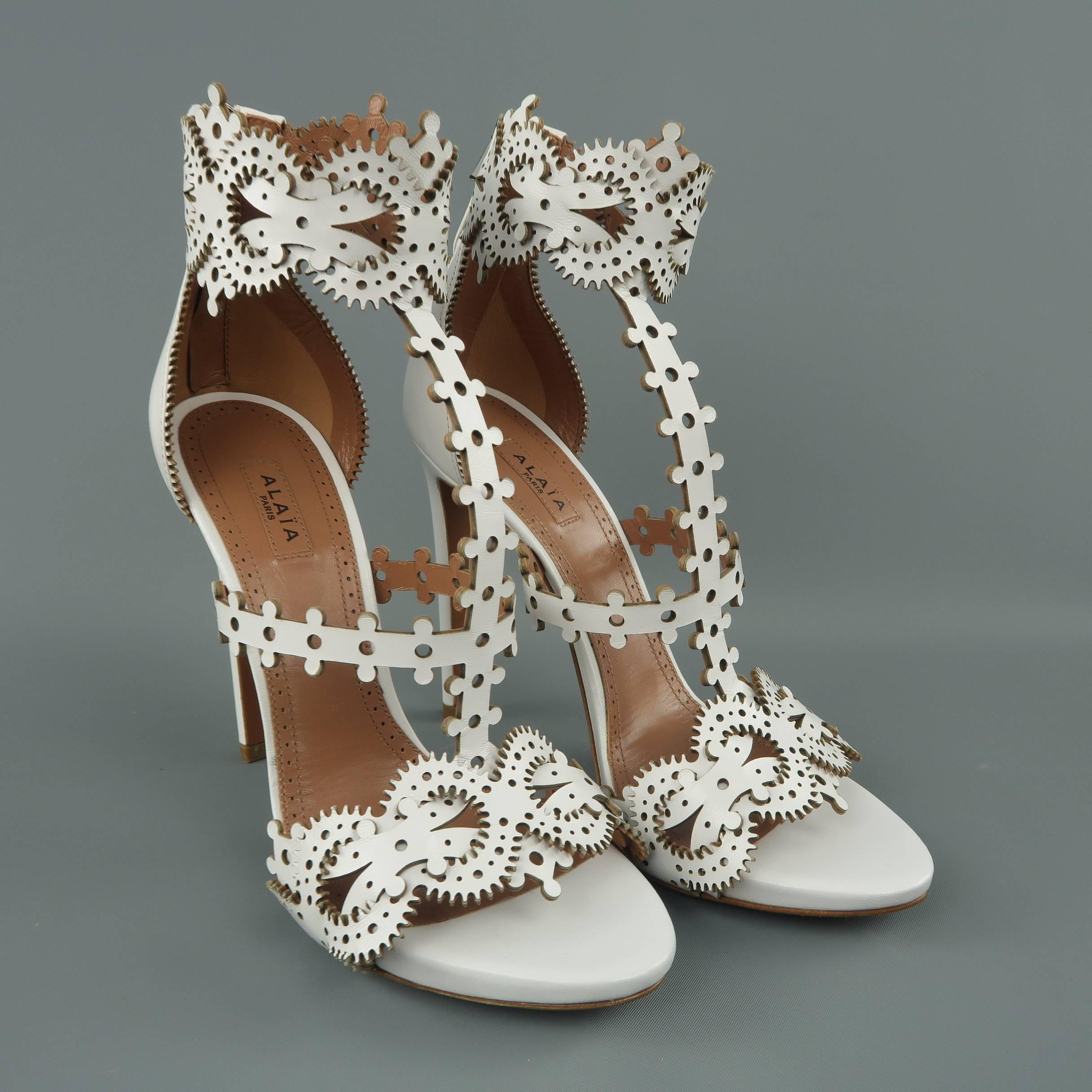 ALAIA sandals come in white leather with laser cut pattern straps and a covered stiletto heel. Made in Italy.
 
Brand New.
Marked: IT 38.5
 
Heel: 4.5 in.
