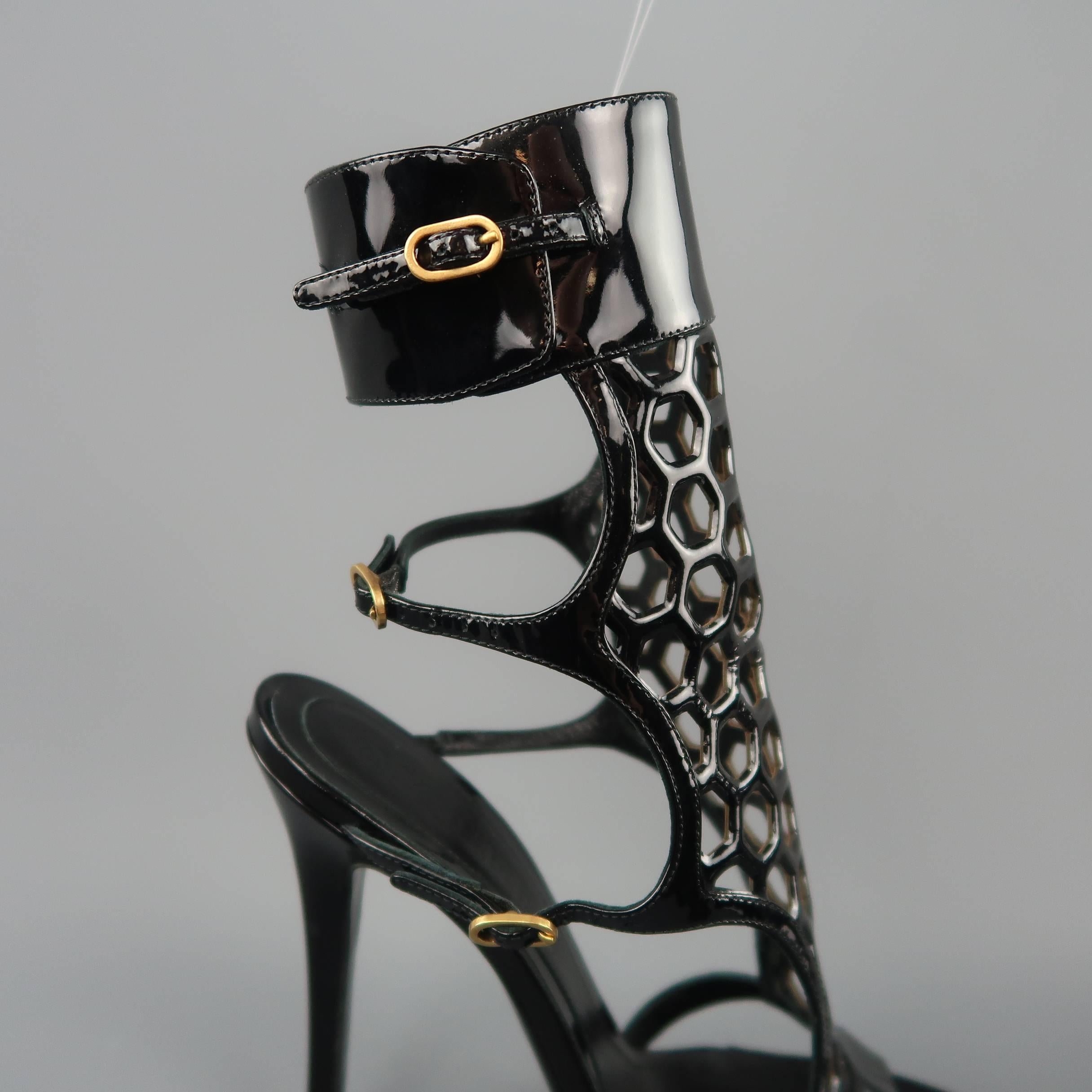 ALEXANDER MCQUEEN sandals come in black patent leather with double buckle side straps, thick ankle strap and honeycomb pattern cutout frontal panel. Worn once. Made in Italy.
 
Excellent Pre-Owned Condition.
Marked: IT 39
 
Measurements:
 
Heel: 5