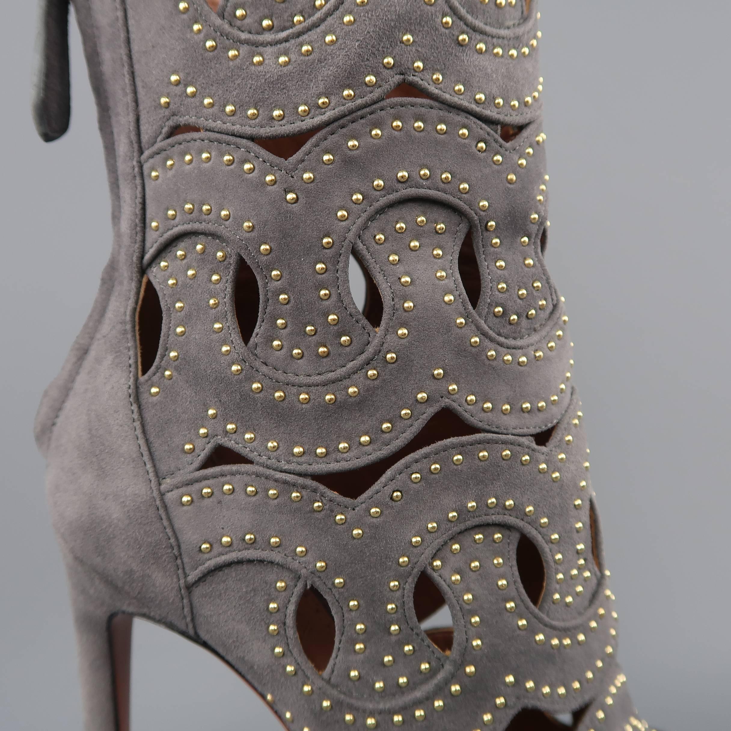 ALAIA ankle boots come in gray suede with woven cutout pattern and gold tone studs throughout, peep toe, and covered stiletto heel. Never worn. Made in Italy.
 
Brand New.
Marked: IT 38.5
 
Measurements:
 
Heel: 4.5 in.
