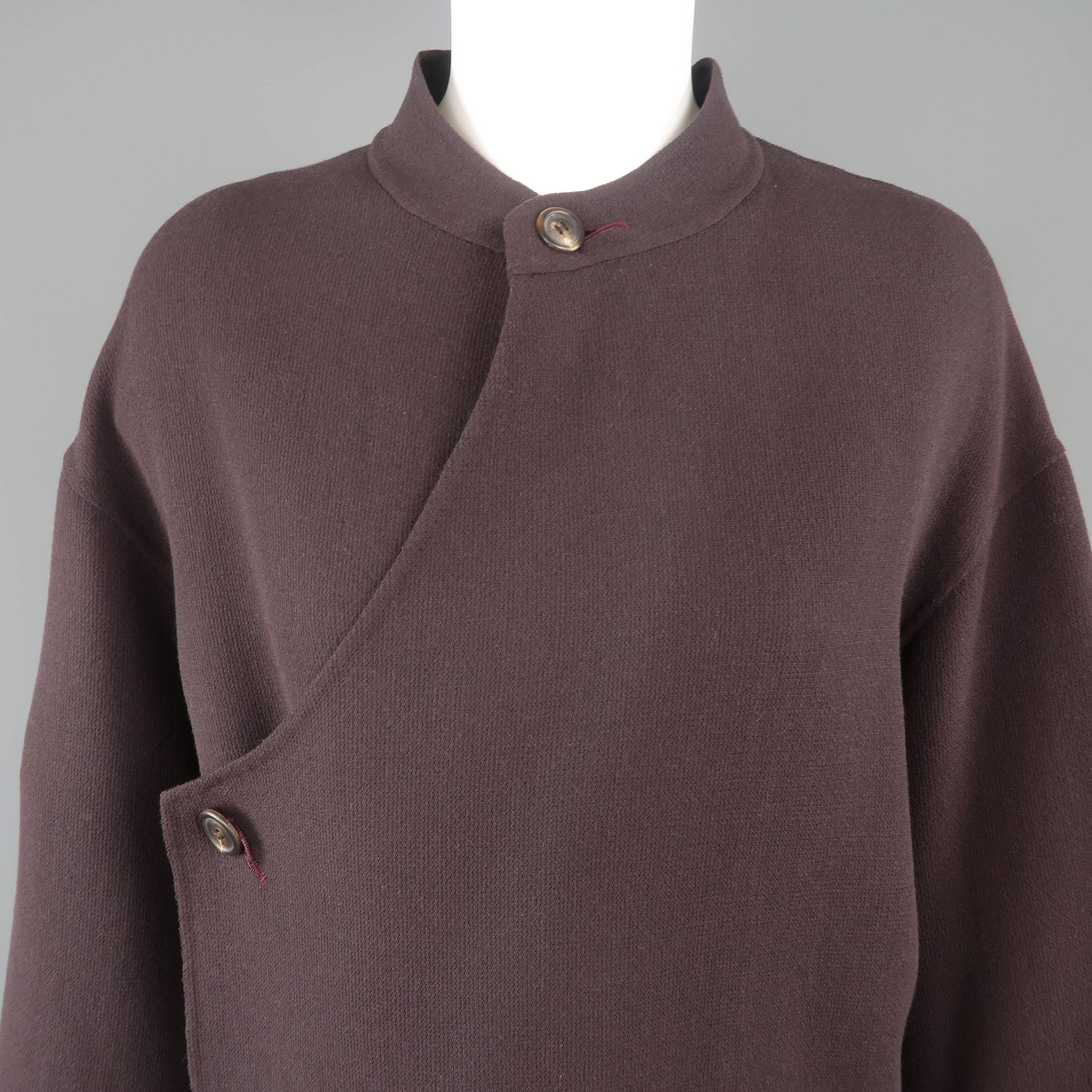 Vintage ISSEY MIYAKE coat comes in plum purple textured wool crepe with a band collar, asymmetrical double breasted closure, and slip pockets with buttons. Made in Japan.
 
Excellent Pre-Owned Condition.
Marked: L
 
Measurements:
 
Shoulder: 22