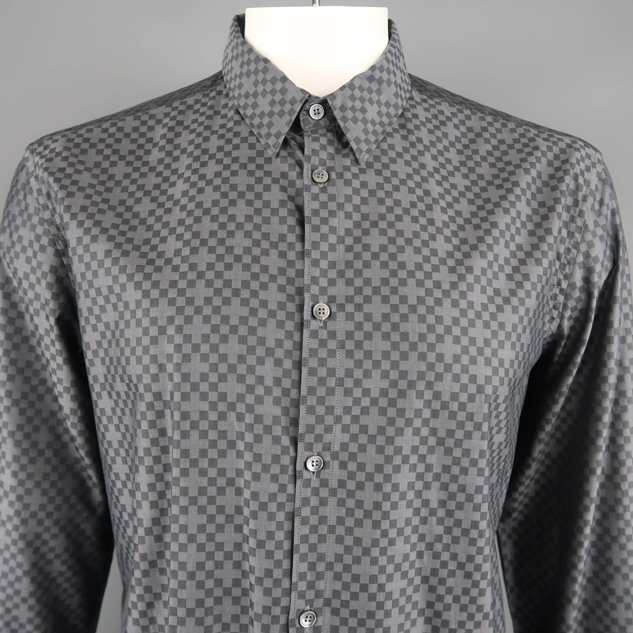 Versace dress shirt comes in dark gray cotton with a pointed collar and all over checkered cross print. Made in Italy.
 
Excellent Pre-Owned Condition.
Marked: IT 43 / 17
 
Measurements:
 
Shoulder: 18 in.
Chest: 46 in.
Sleeve: 29 in.
Length: 31 in.
