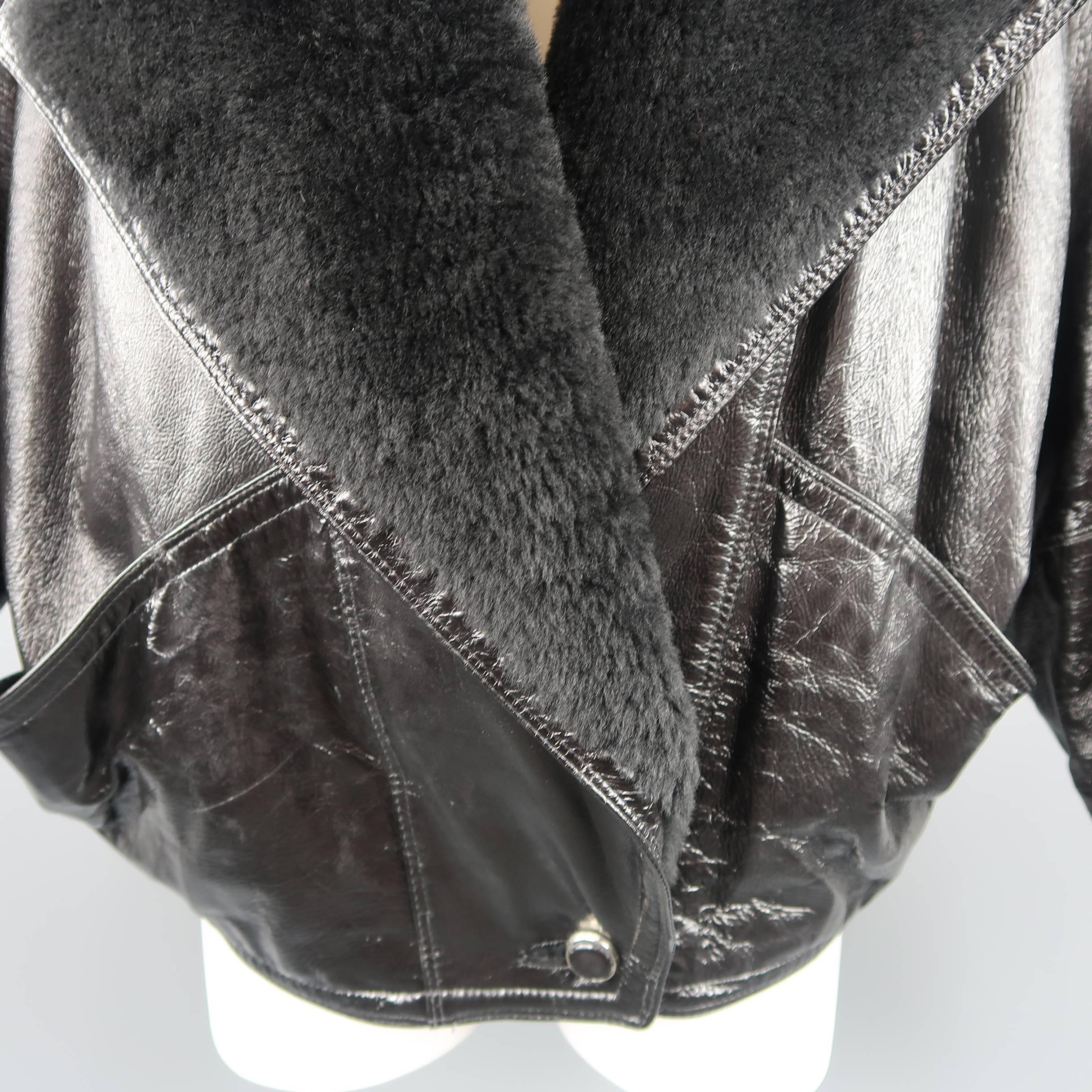 Vintage 1980's GIANNI VERSACE jacket comes in black textured patent leather with a large, shearling fur pointed lapel, oversized silhouette, single button, double breasted closure, batwing raglan sleeves, and slit pockets. Made in Italy.
 
Good