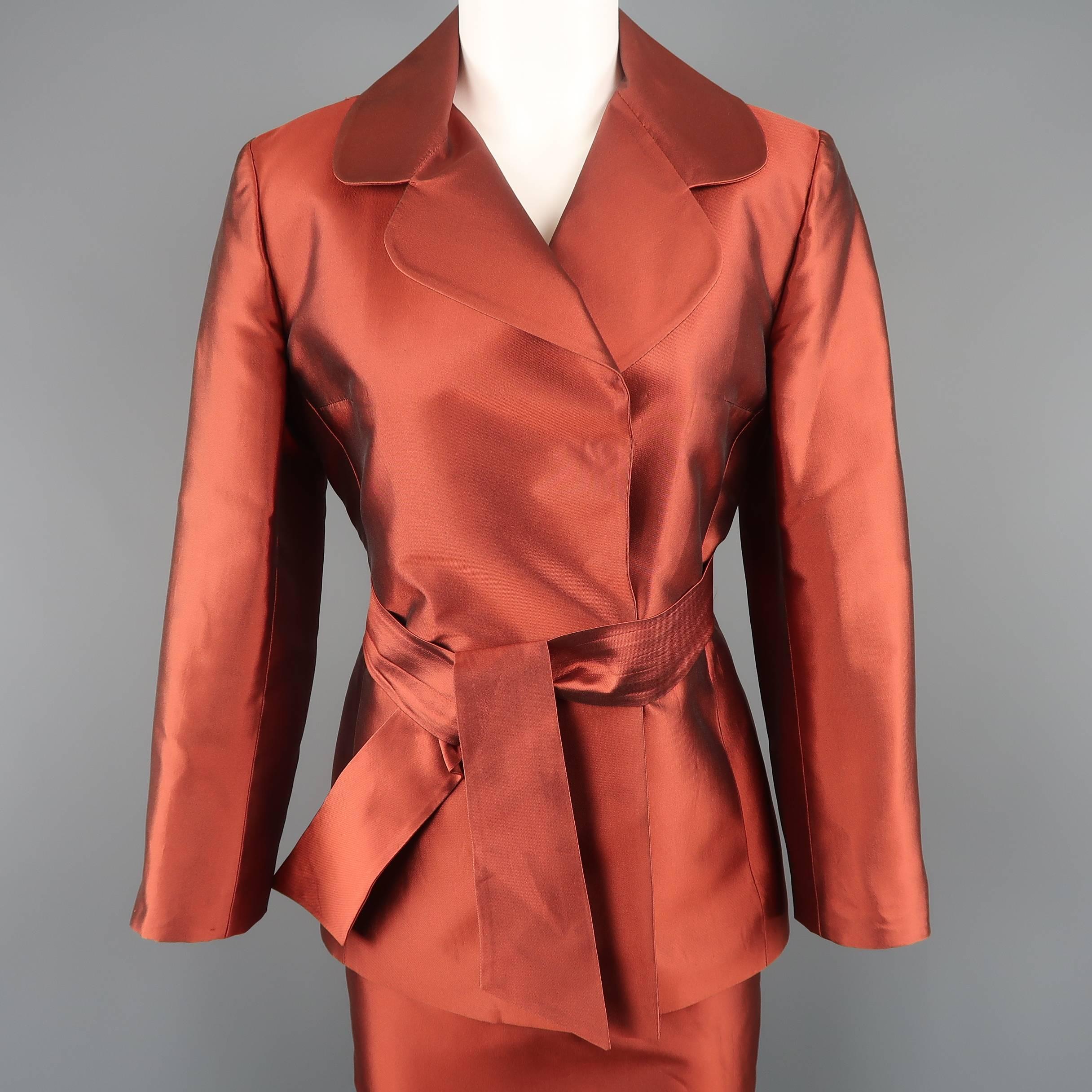 Archive DOLE & GABBANA suit comes in a gorgeous iridescent copper red silk taffeta and includes a hidden snap closure, double breasted jacket with round lapel and sash belt with a matching high rise skirt. Care tags removed and minor wear