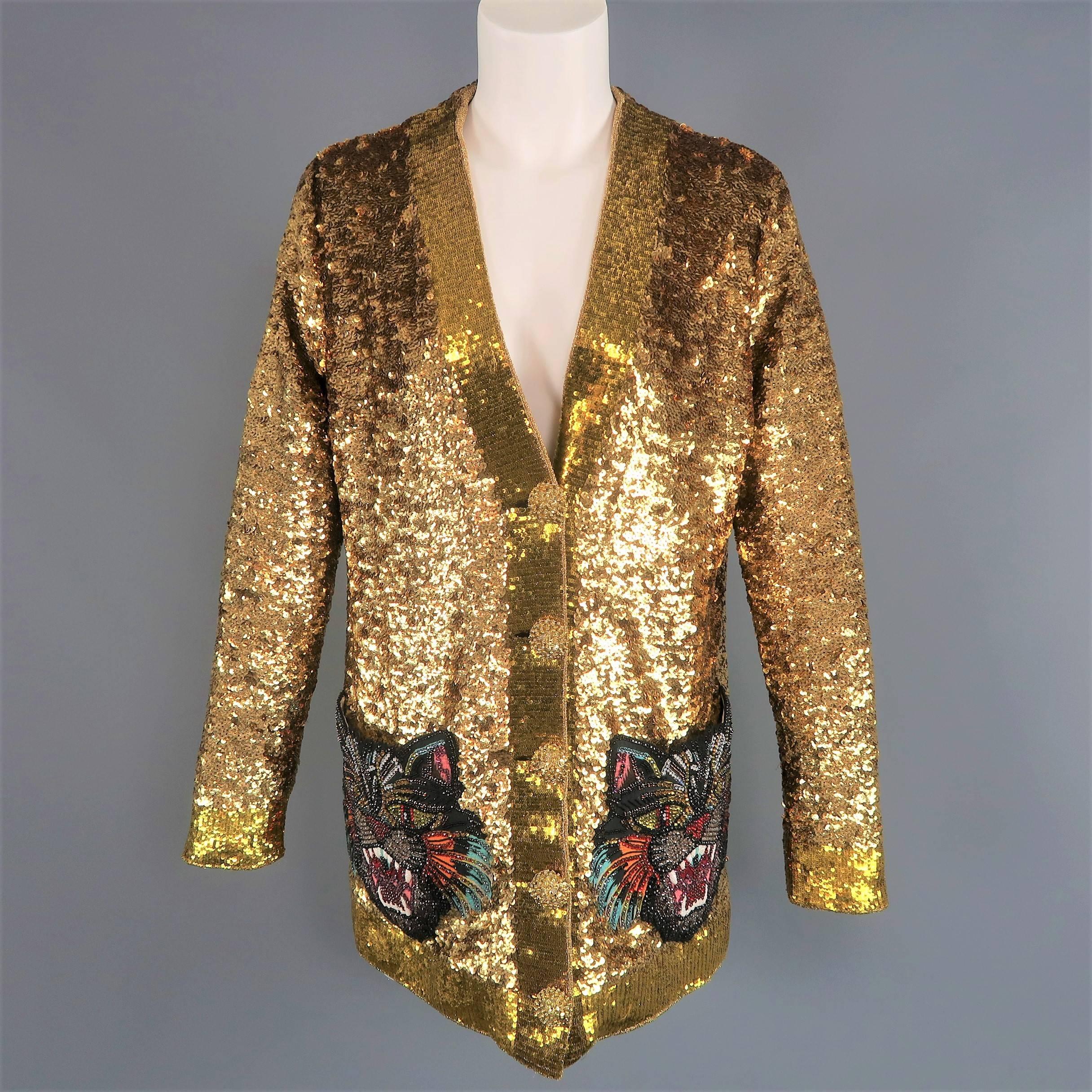 Gucci Spring 2017 Collection cardigan jacket comes in gold sequin embellished silk with yellow gold sequin trim, V neckline, five beaded button closure front, oversized multi colored rhinestone studded black tiger pockets, and teal and pink lion