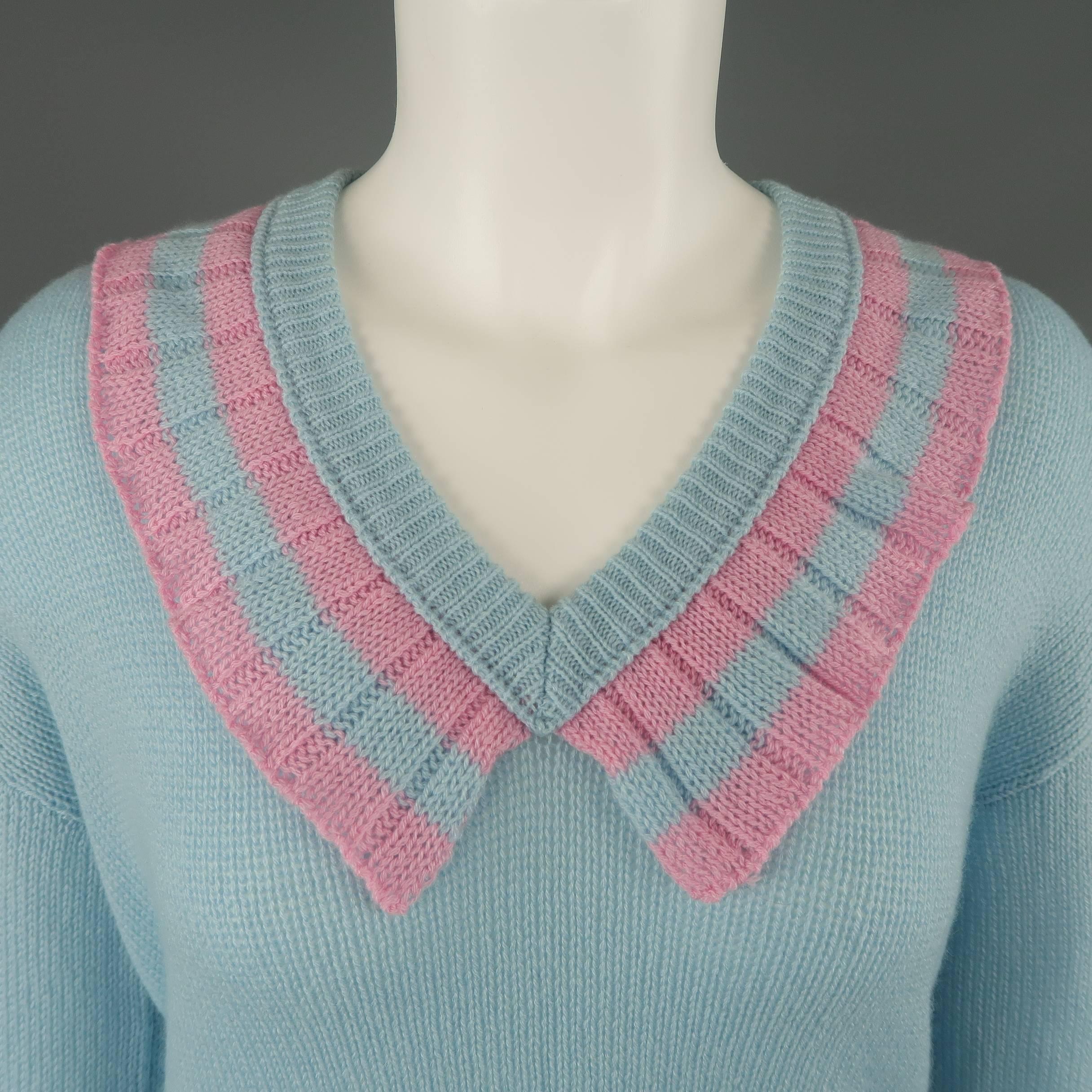 Prada pullover sweater comes in light blue cashmere with an oversized fit and V neck with pink striped riffle collar trim. Made in Italy.
 
Good Pre-Owned Condition.
Marked: IT 38
Retails at: $1,080.00
 
Measurements:
 
Shoulder: 20 in.
Bust: 40