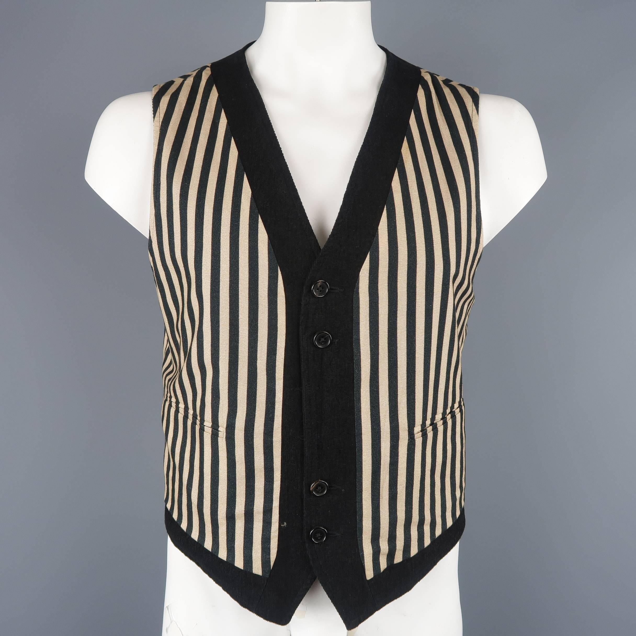 Ann Demeulemeester reversible vest comes in black corduroy with patch pockets with a reverse black and beige striped fabric side. Hole on front and wear. As-is. Made in Tunisia.
 
Fair Pre-Owned Condition.
Marked: L
 
Measurements:
 
Shoulder: 16