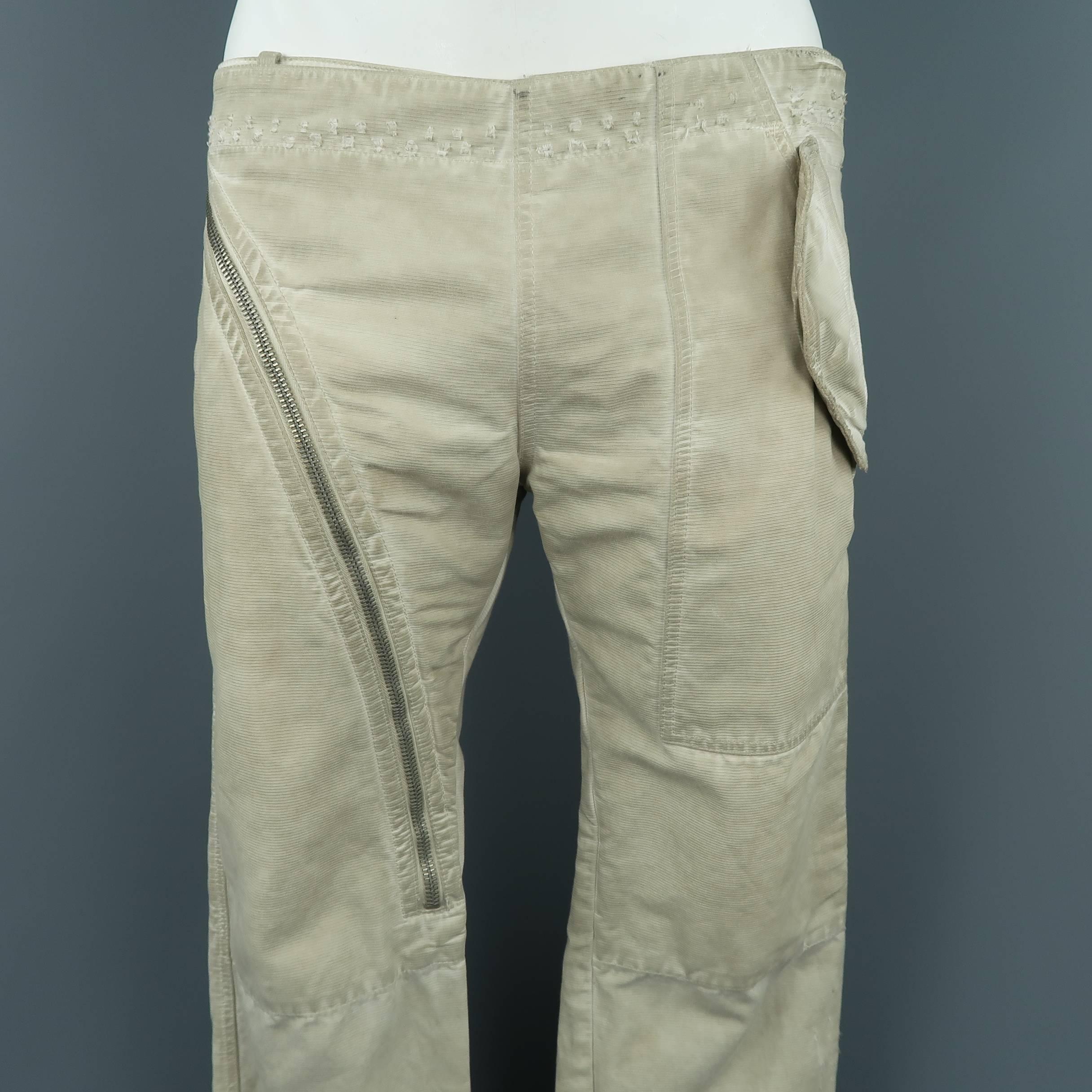 DRKSHDW by Rick Owens pants comes in dirty wash distressed textured denim with flap pockets and zip over panel closure. Made in Italy.
 
Good Pre-Owned Condition.
Marked: 31
 
Measurements:
 
Waist: 34 in.
Rise: 9 in.
Inseam:  34 in.
