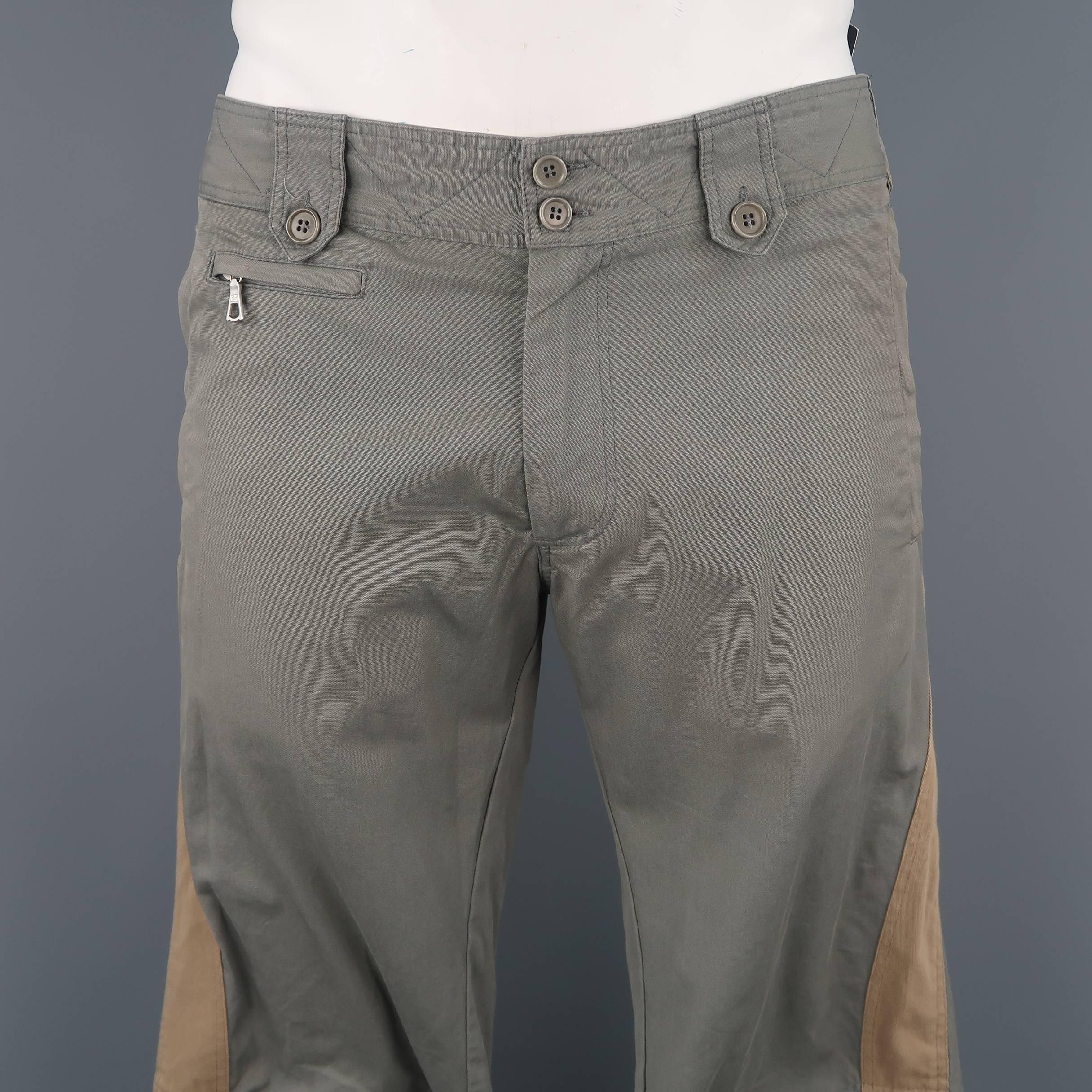Dries Van Noten motorcycle pants comes in light neutral gray cotton canvas with snap and zip pockets tan stripe panels, darted knees, and zip cuffs. Made in Romania.
 
Excellent Pre-Owned Condition.
Marked: IT 50
 
Measurements:
 
Waist: 34