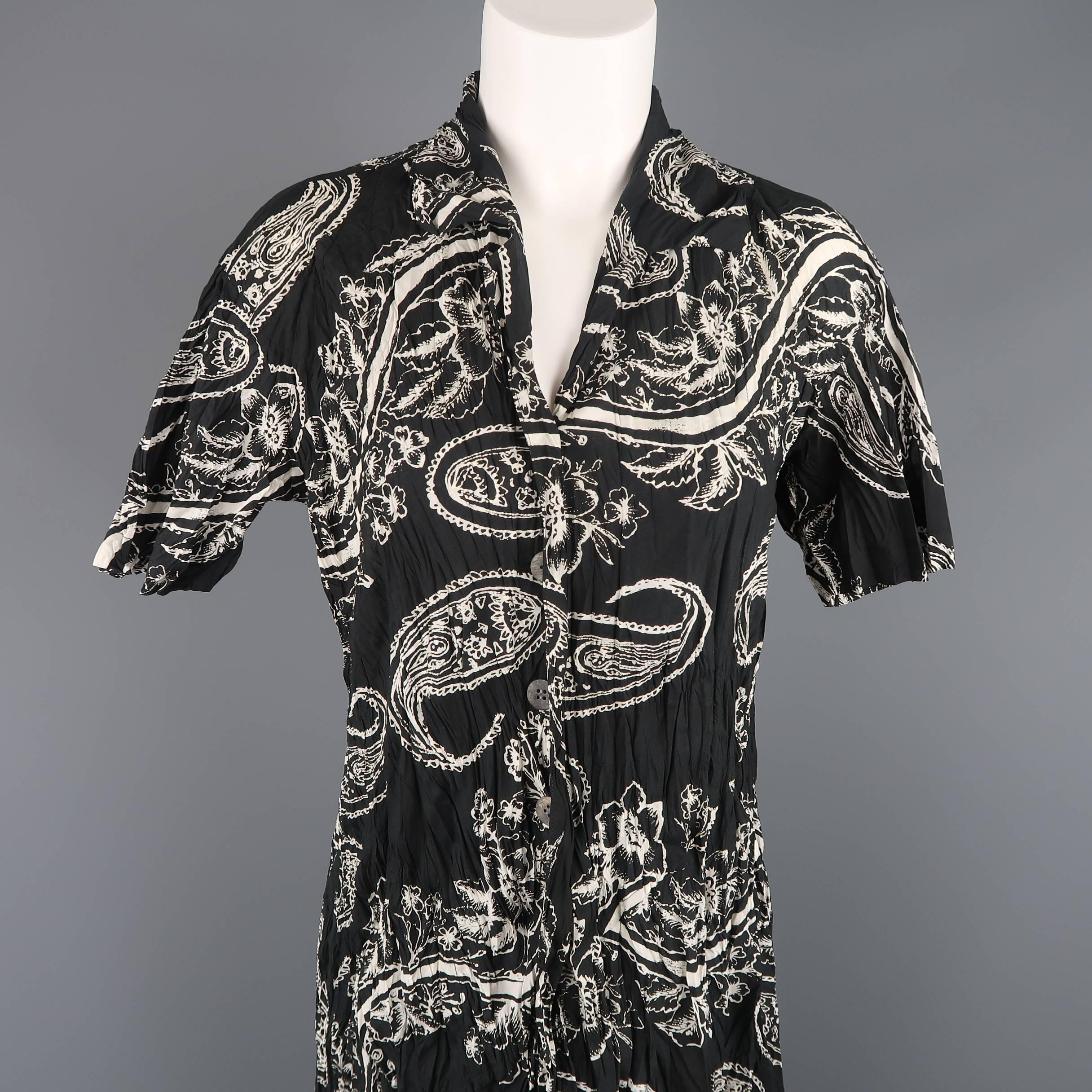 Vintage Issey Miyake dress comes in black and beige floral paisley print wrinkle textured fabric with a pointed collar, half button front, short sleeves, and A line long skirt with front pleat. Made in Japan.
 
Excellent Pre-Owned Condition.
Marked: