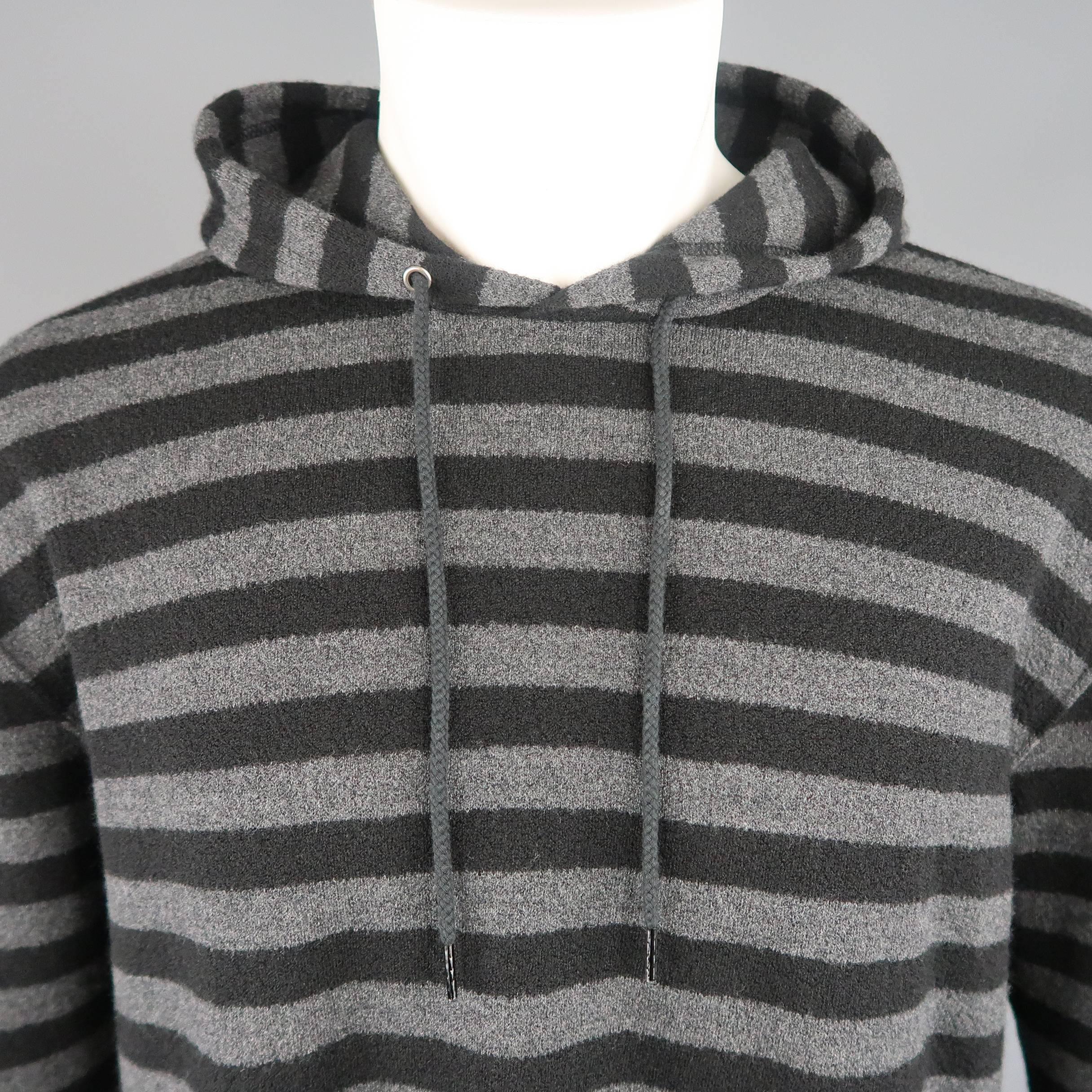 Junya Watanabe Man hoodie comes in black and gray striped wool textured knit with side pockets and drawstring hood. Made in Japan.
 
New with Tags.
Marked: S
 
Measurements:
 
Shoulder: 22 in.
Chest: 46 in.
Sleeve: 22 in.
Length: 30 in.
