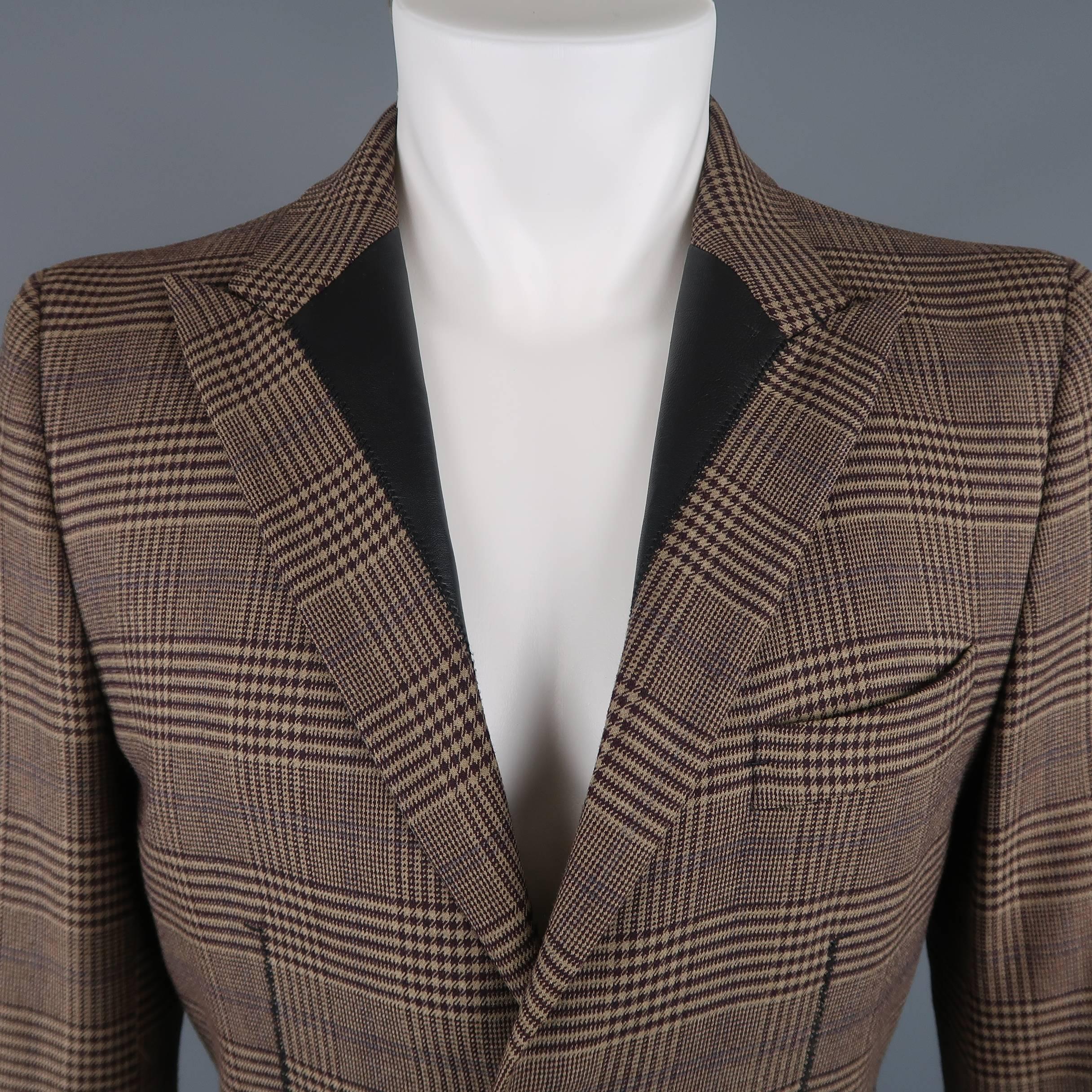 Vintage GAULTIER2 by Jean Paul Gaultier  sport coat comes in tan wool blend with eggplant purple plaid print throughout, two button front, functional button cuffs, and peak lapel with black leather details. Made in Italy.
 
Excellent Pre-Owned
