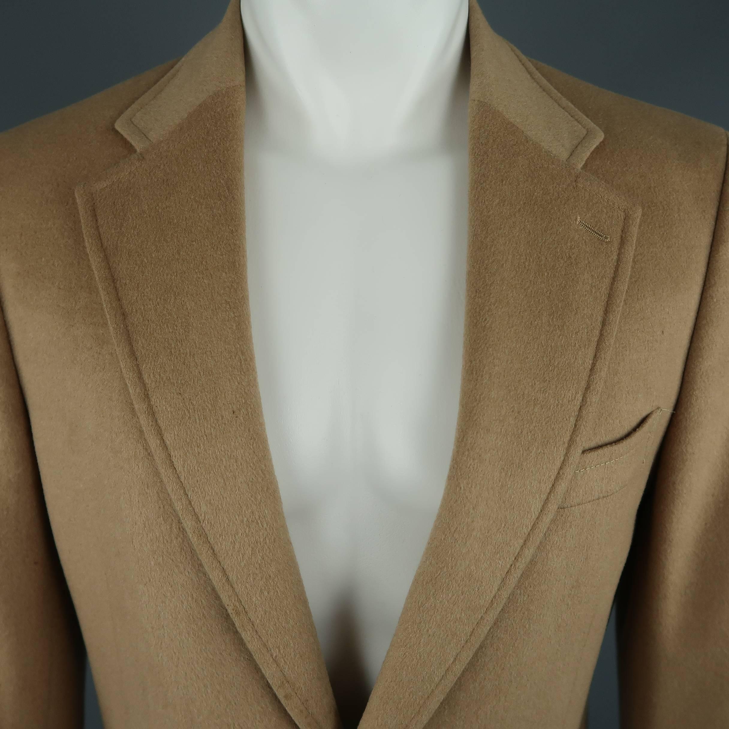 
Prada sport coat comes in tan camel hair and features a notch lapel, two button front, and patch pockets. Stains throughout. As is. Made in Italy.
 
Fair Pre-Owned Condition.
Marked: IT 50 R
 
Measurements:
 

    Shoulder: 17 in.
    Chest: 40