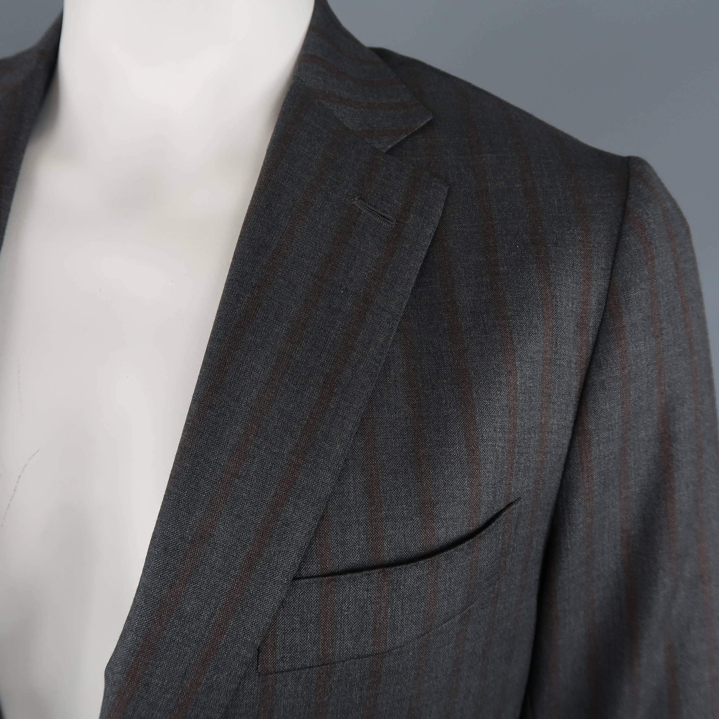 Single breasted ISAIA sport coat comes in dark gray and brown striped wool with a notch lapel, two button closure, and functional button cuffs.  Made in Italy.
 
Excellent Pre-Owned Condition.
Marked: IT 52
Measurements:
 
Shoulder: 17 in.
Chest: 44